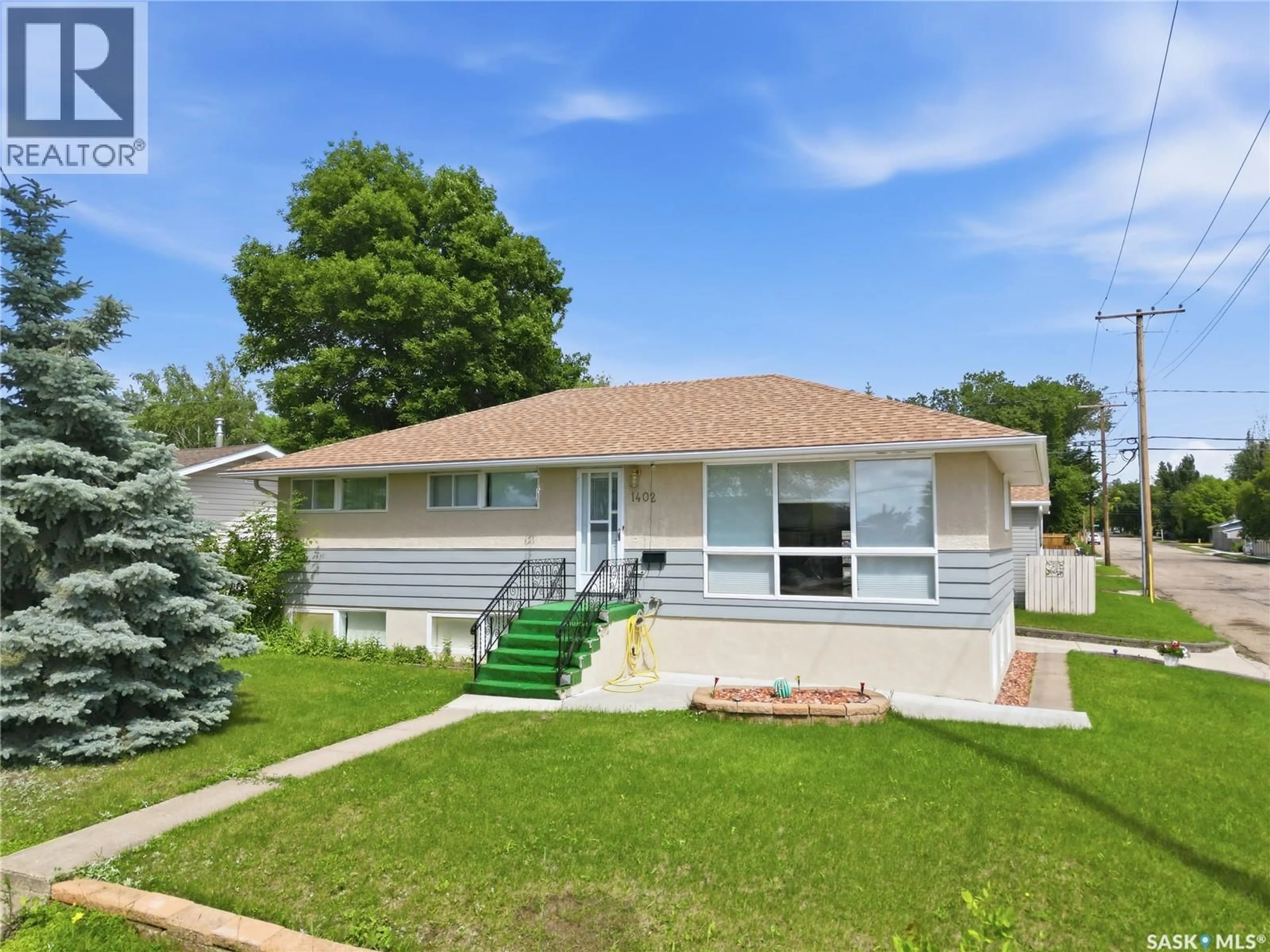 Home with vinyl exterior material, street for 1402 93RD STREET, North Battleford Saskatchewan S9A0C1