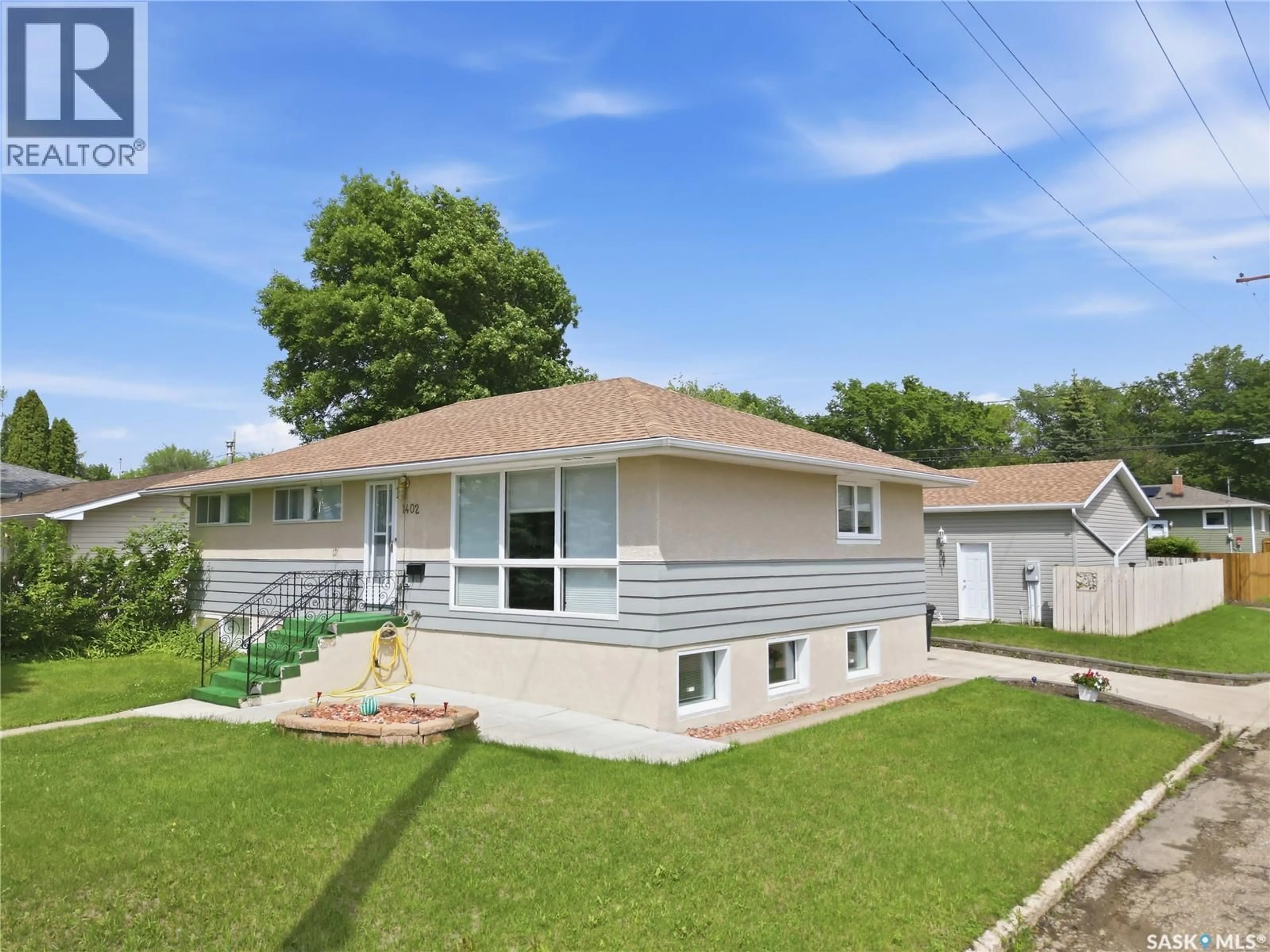 Home with vinyl exterior material, street for 1402 93RD STREET, North Battleford Saskatchewan S9A0C1