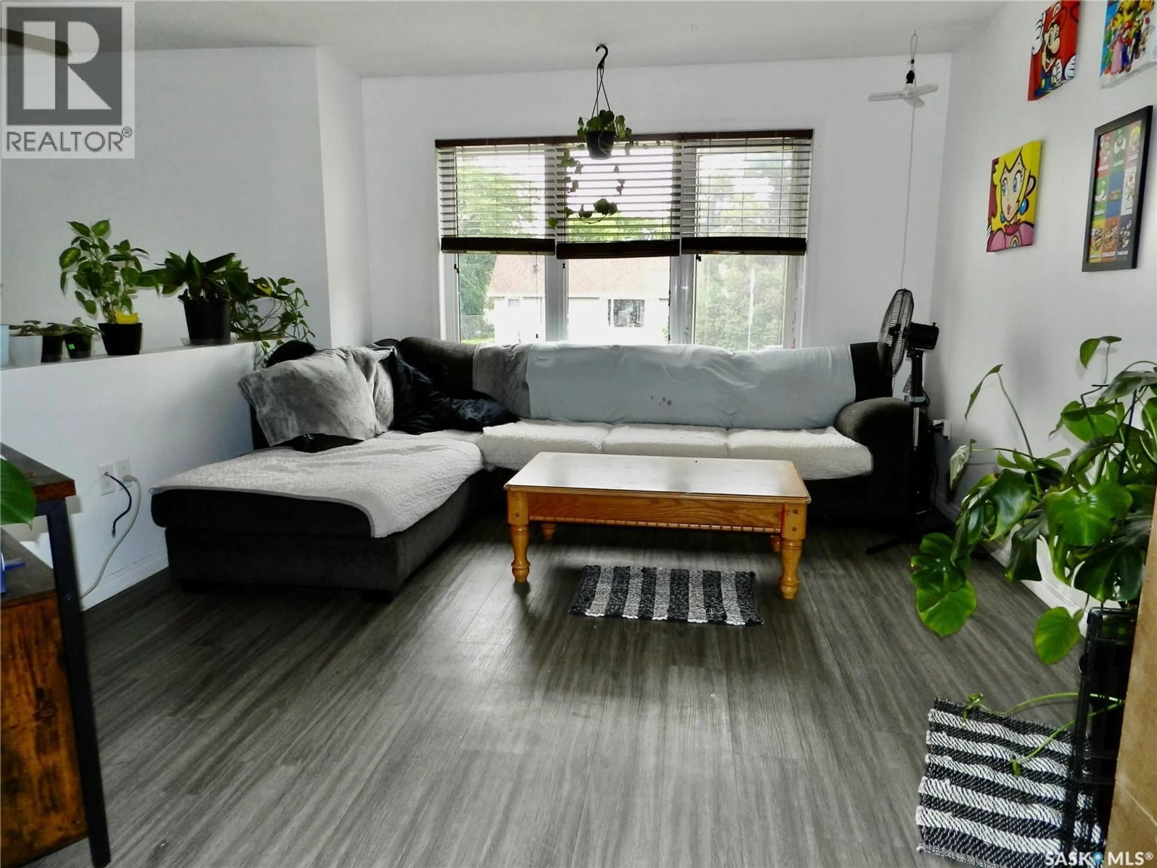Living room with furniture, wood/laminate floor for 907 OMINICA STREET, Moose Jaw Saskatchewan S6H0J1