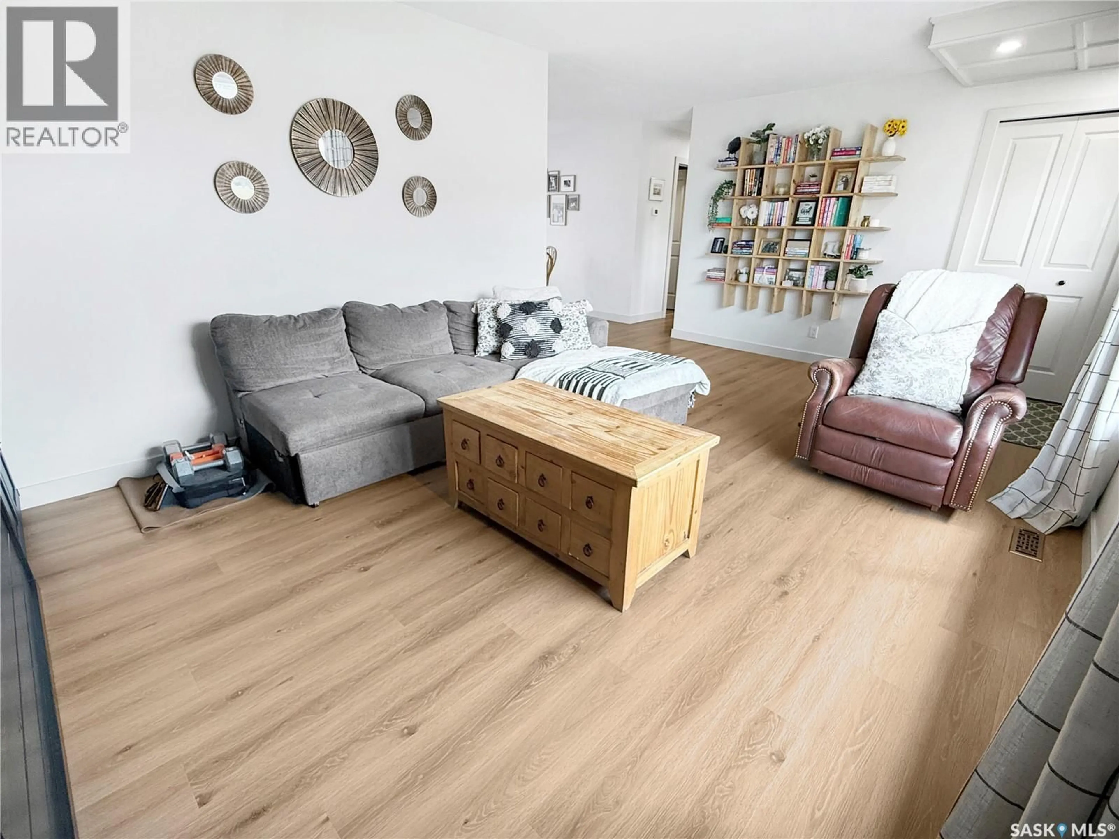 Living room with furniture, wood/laminate floor for 11 HAYWARD PLACE, Swift Current Saskatchewan S9H3Z9