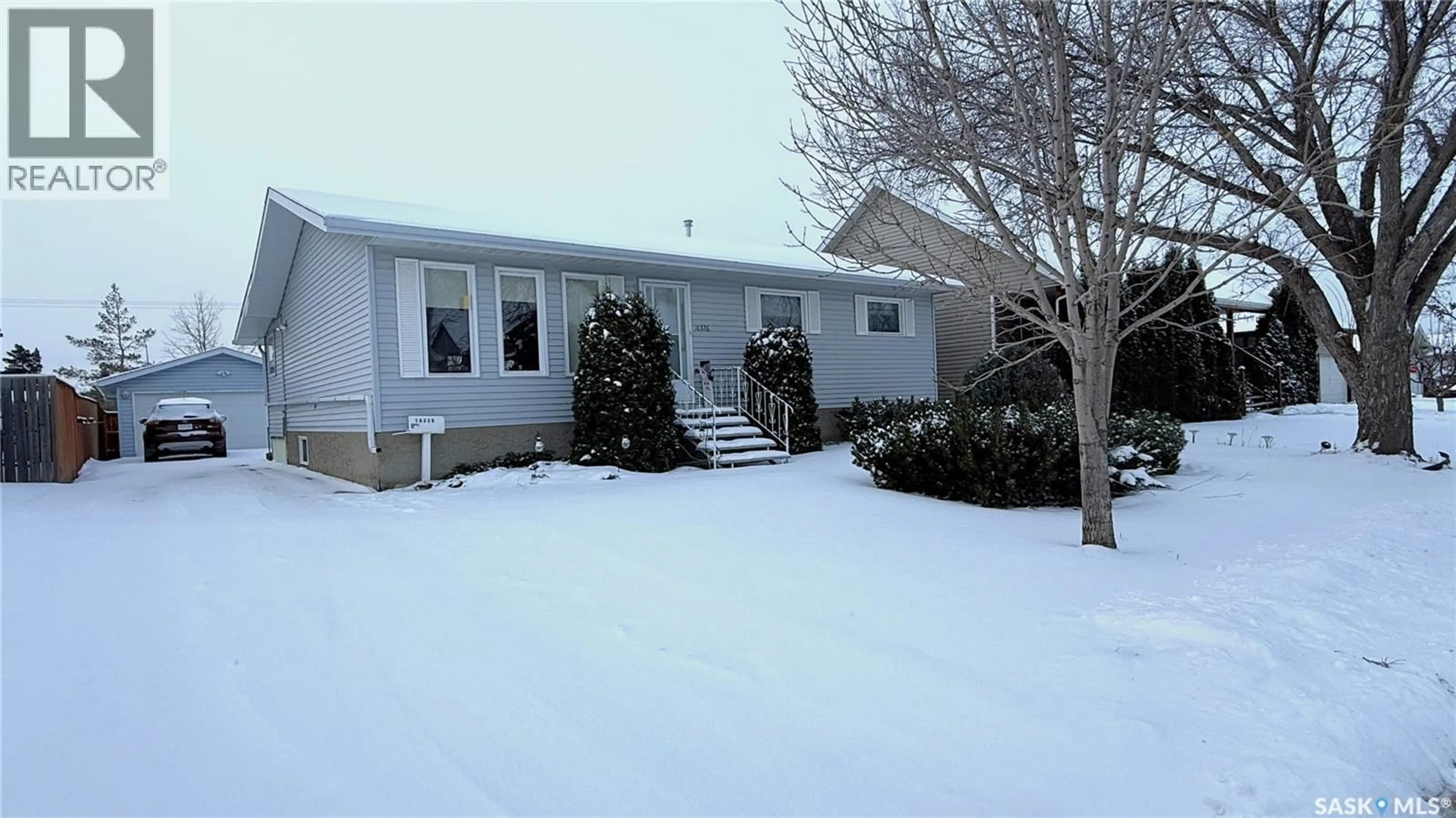 Home with vinyl exterior material, street for 10326 HENDERSON DRIVE, North Battleford Saskatchewan S9A3Y9