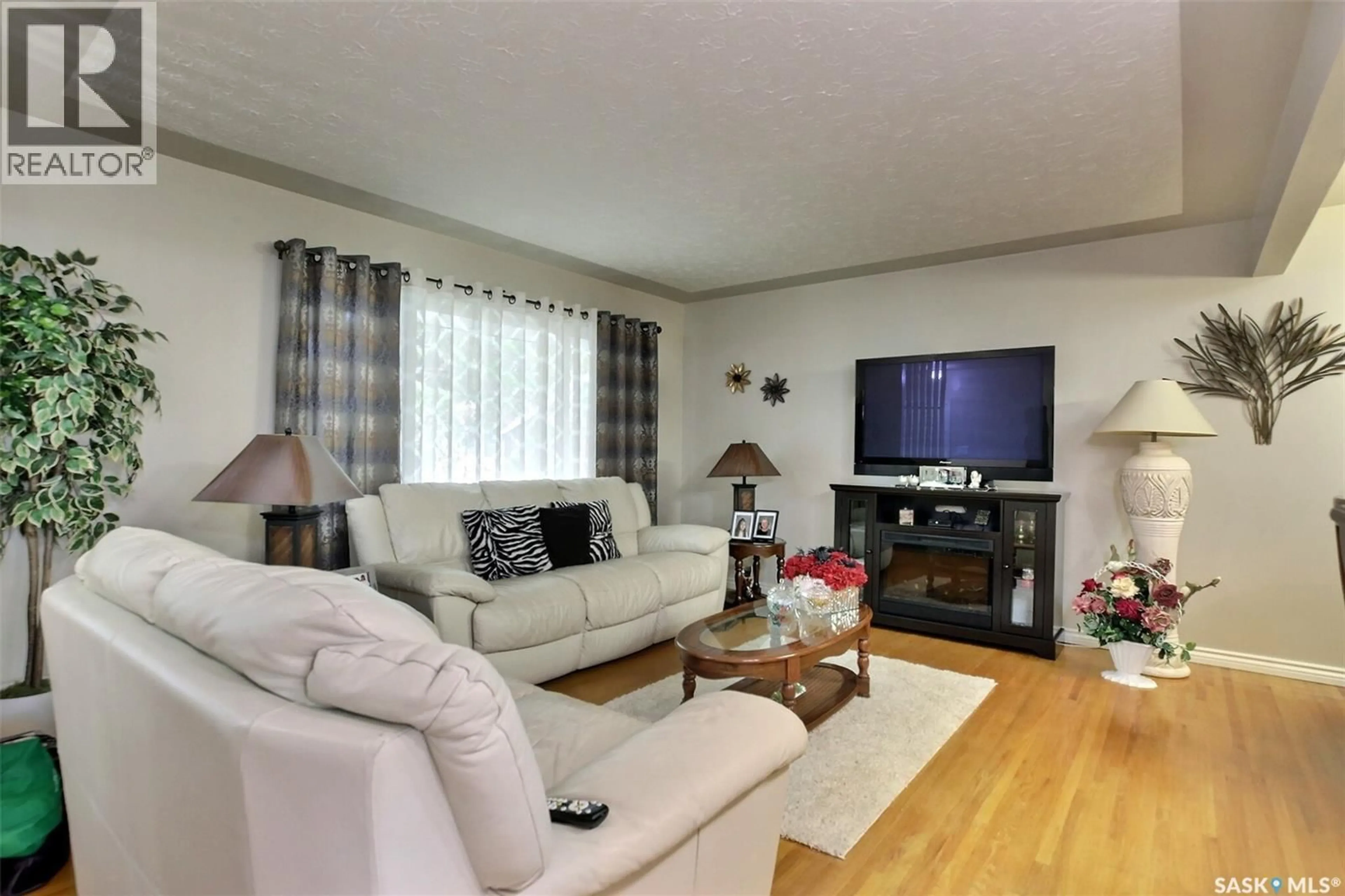 Living room with furniture, wood/laminate floor for 204 RAE STREET, Regina Saskatchewan S4R3L8