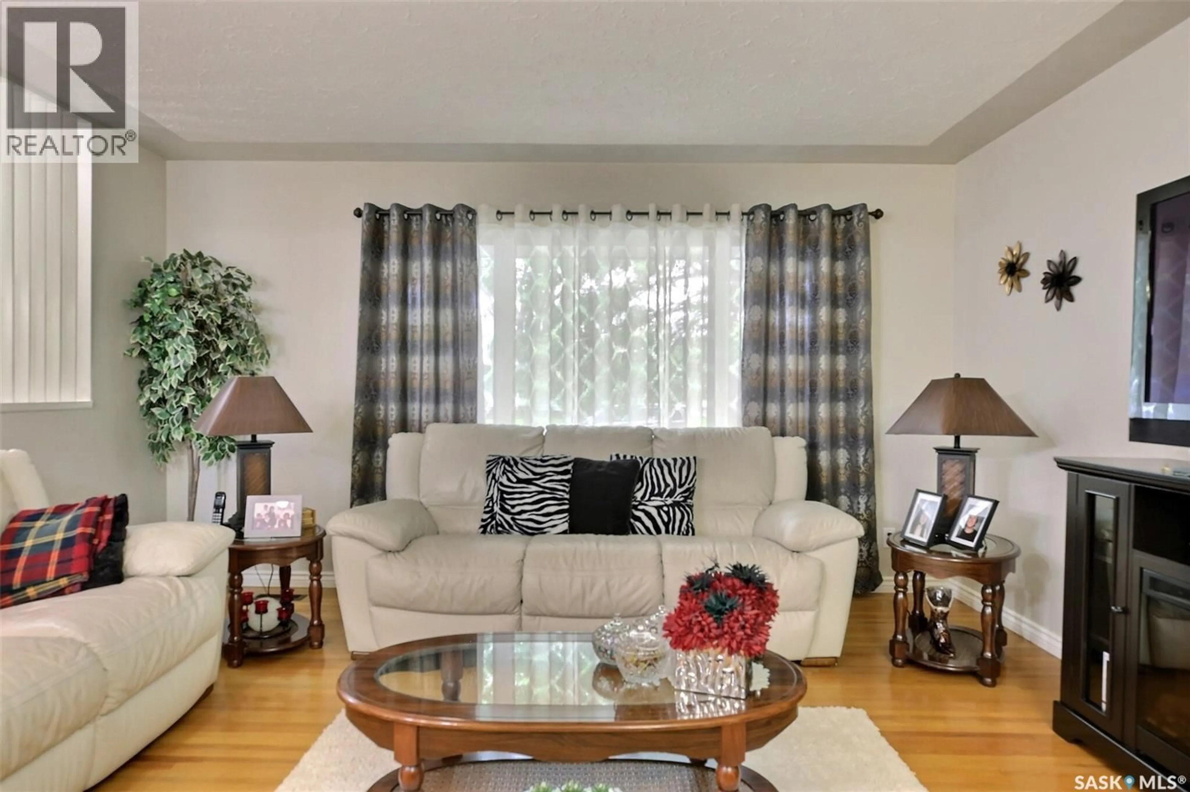 Living room with furniture, wood/laminate floor for 204 RAE STREET, Regina Saskatchewan S4R3L8