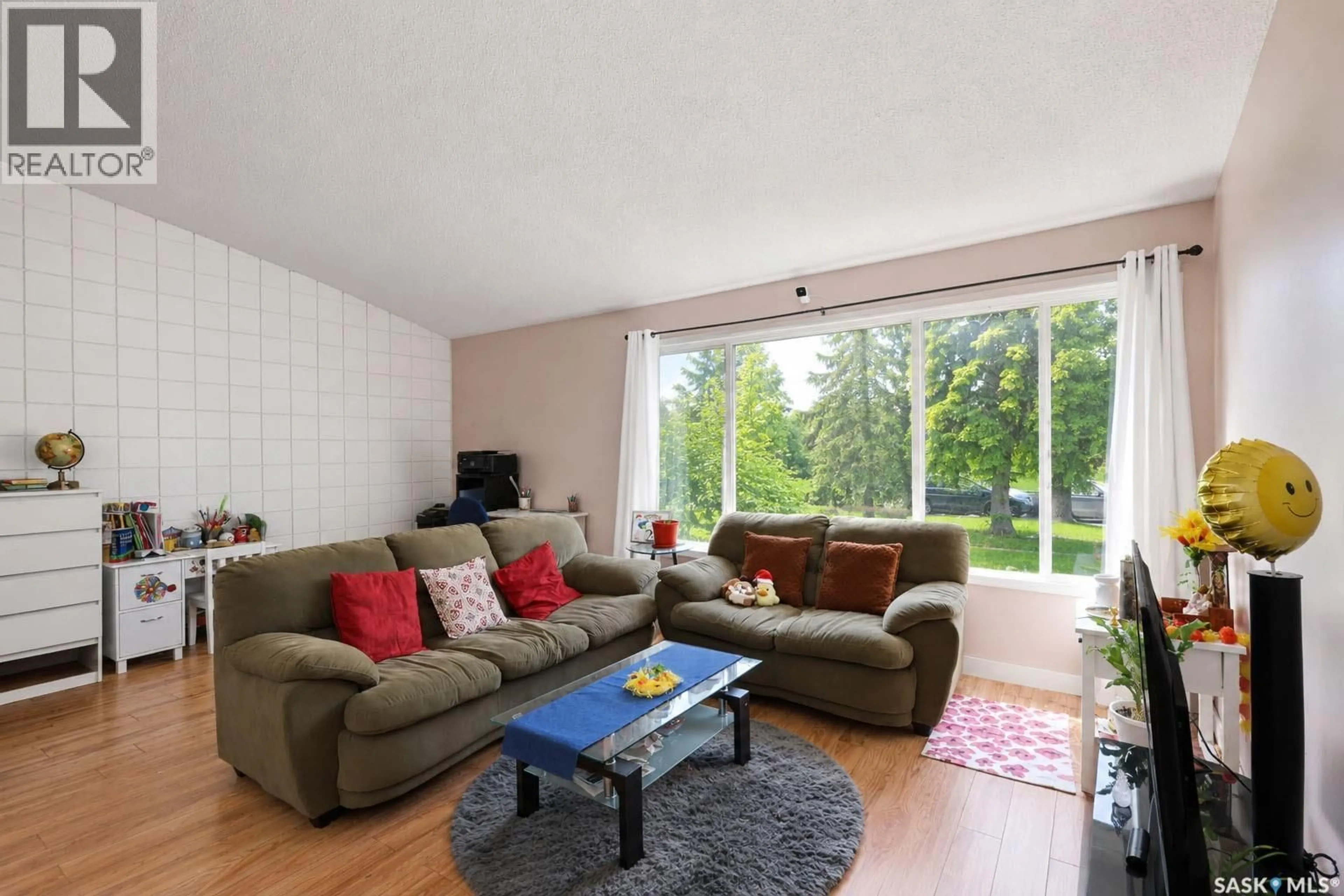Living room with furniture, wood/laminate floor for 842-844 28TH STREET, Prince Albert Saskatchewan S6V1Y1