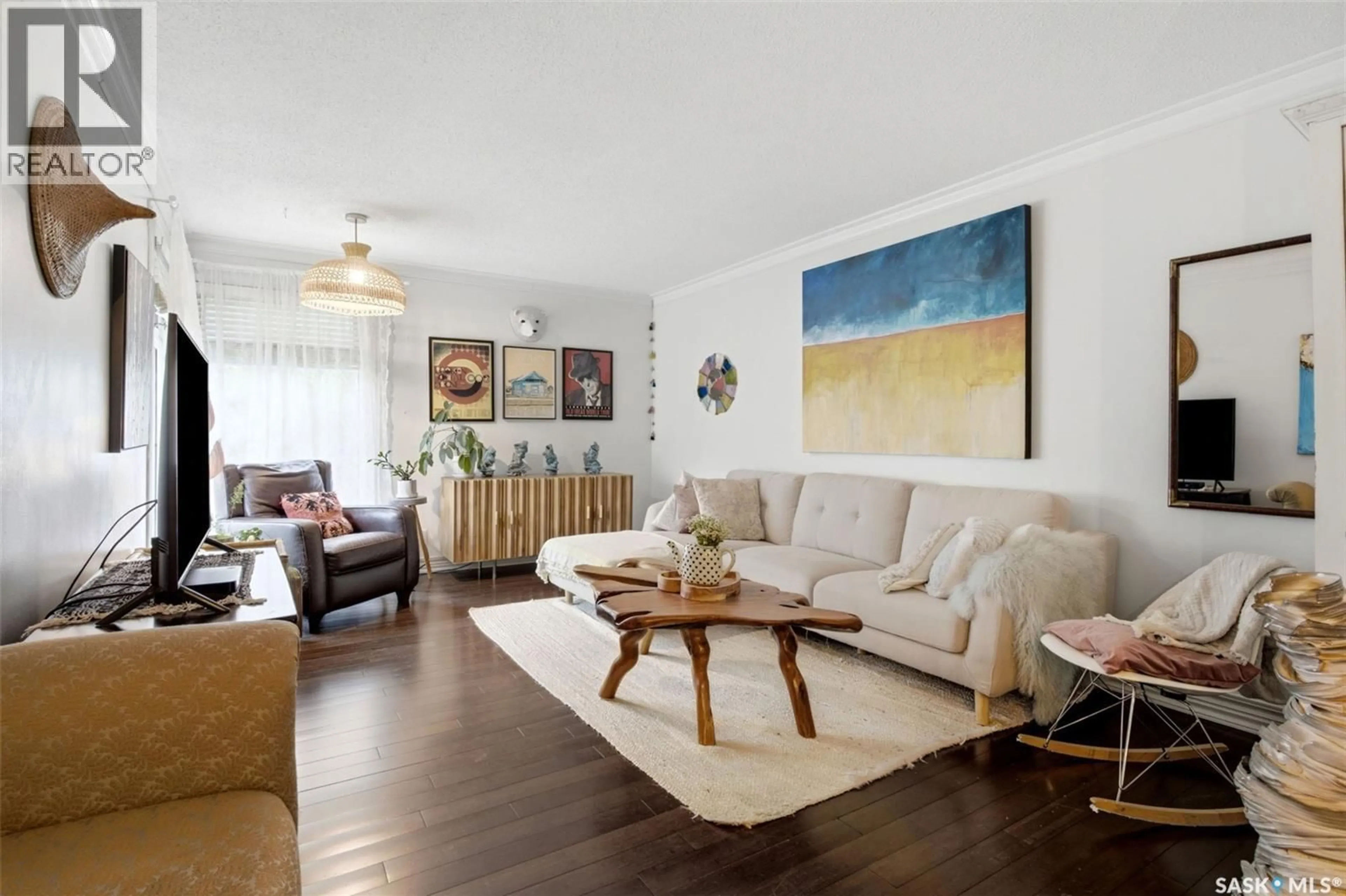 Living room with furniture, wood/laminate floor for 825 SHANNON ROAD, Regina Saskatchewan S4S5K1