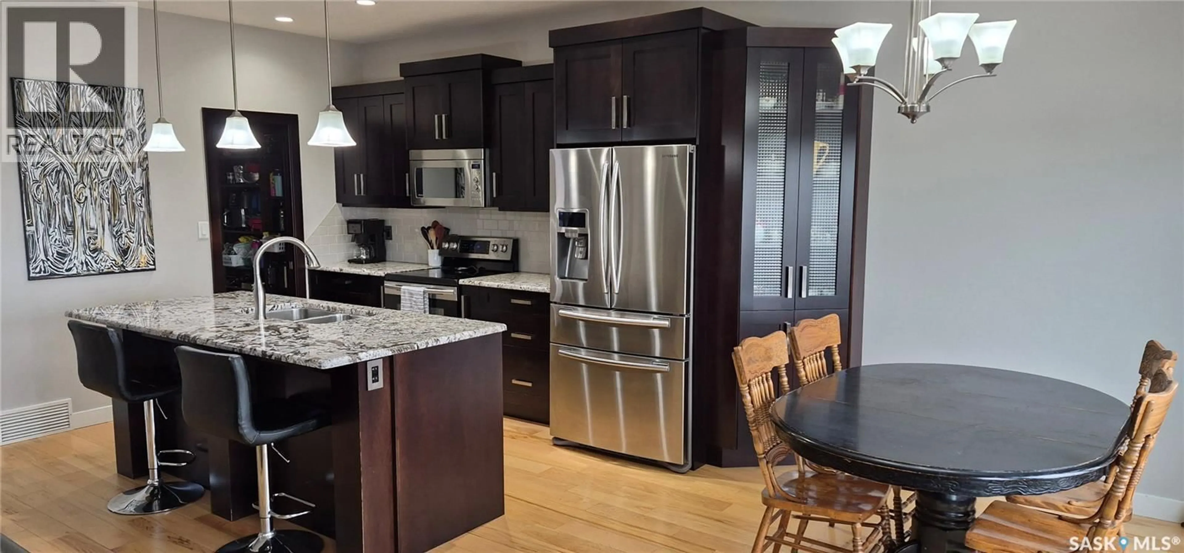 Open concept kitchen, wood/laminate floor for 4741 PADWICK AVENUE, Regina Saskatchewan S4W0C4