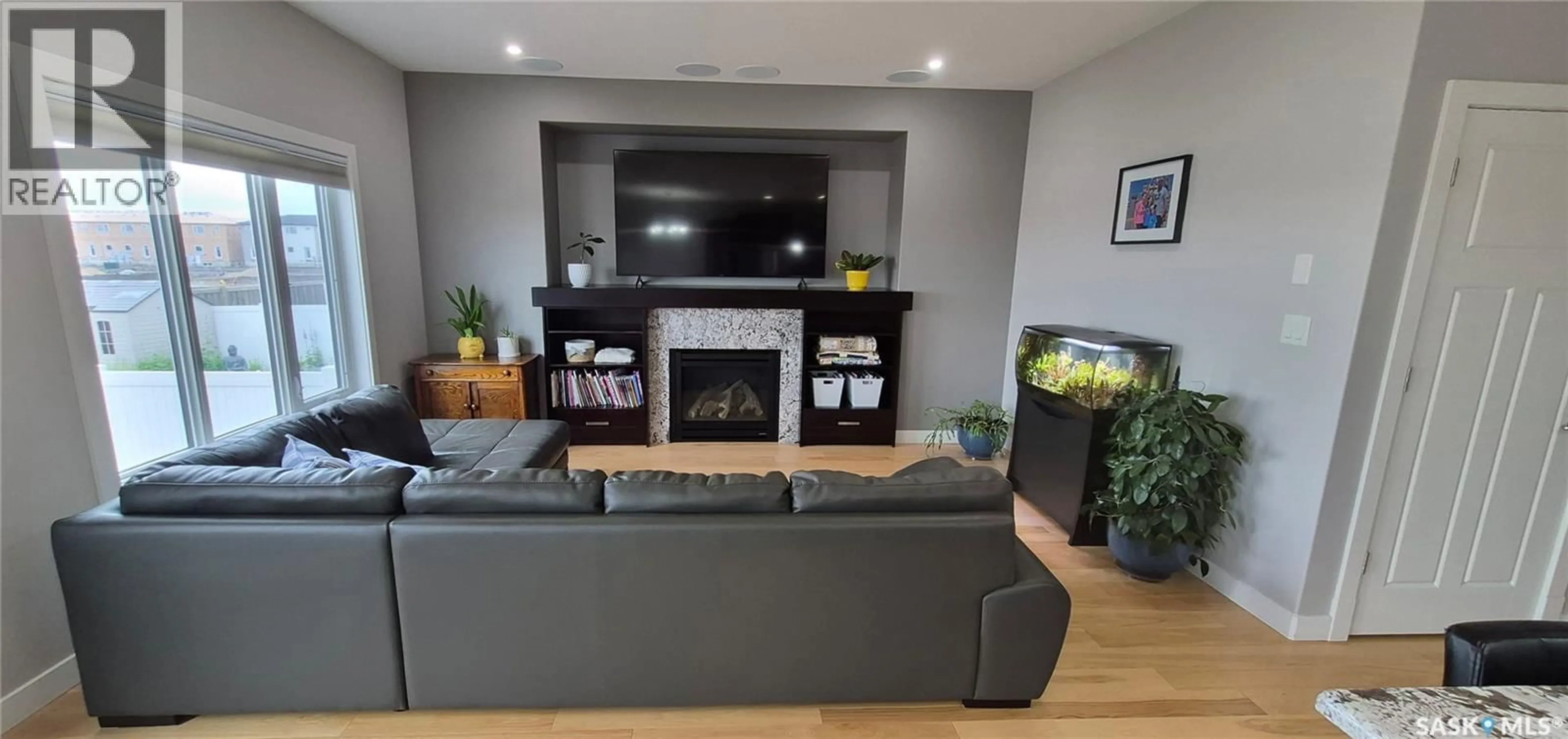 Living room with furniture, wood/laminate floor for 4741 PADWICK AVENUE, Regina Saskatchewan S4W0C4