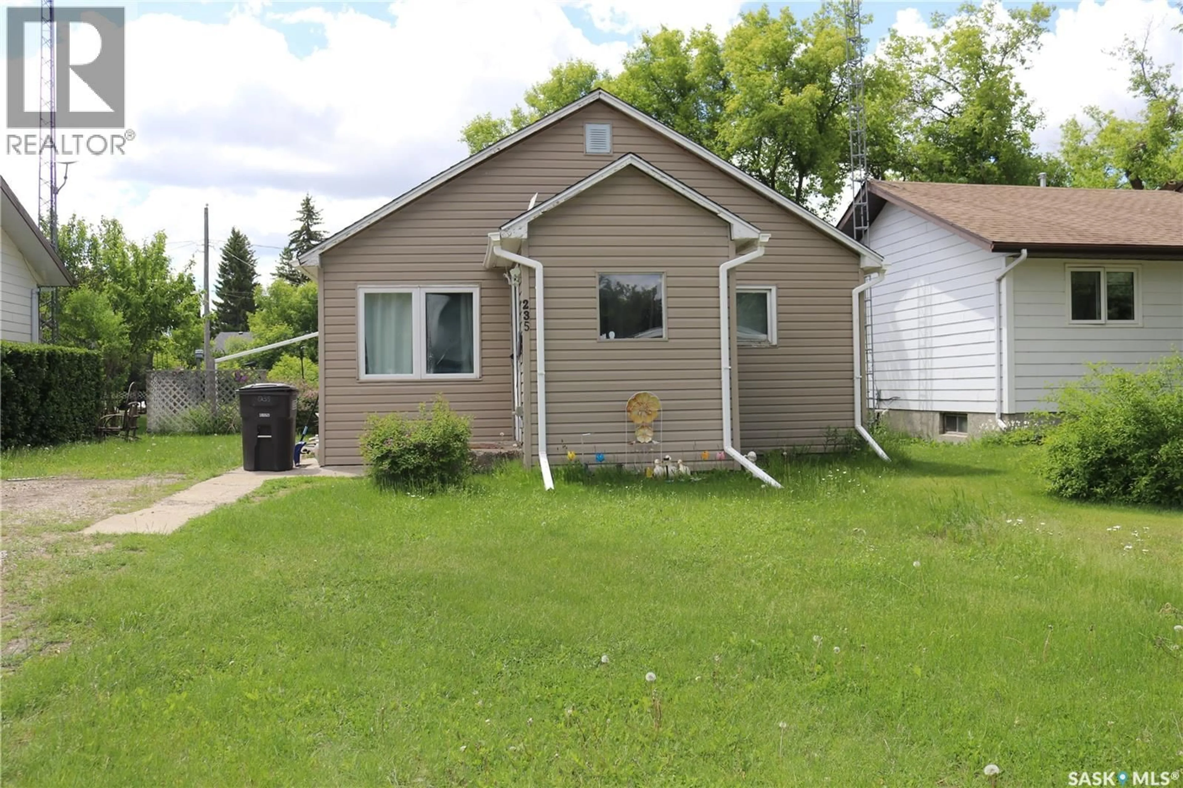 Home with vinyl exterior material, street for 235 GILBERT STREET, Drake Saskatchewan S0K1H0