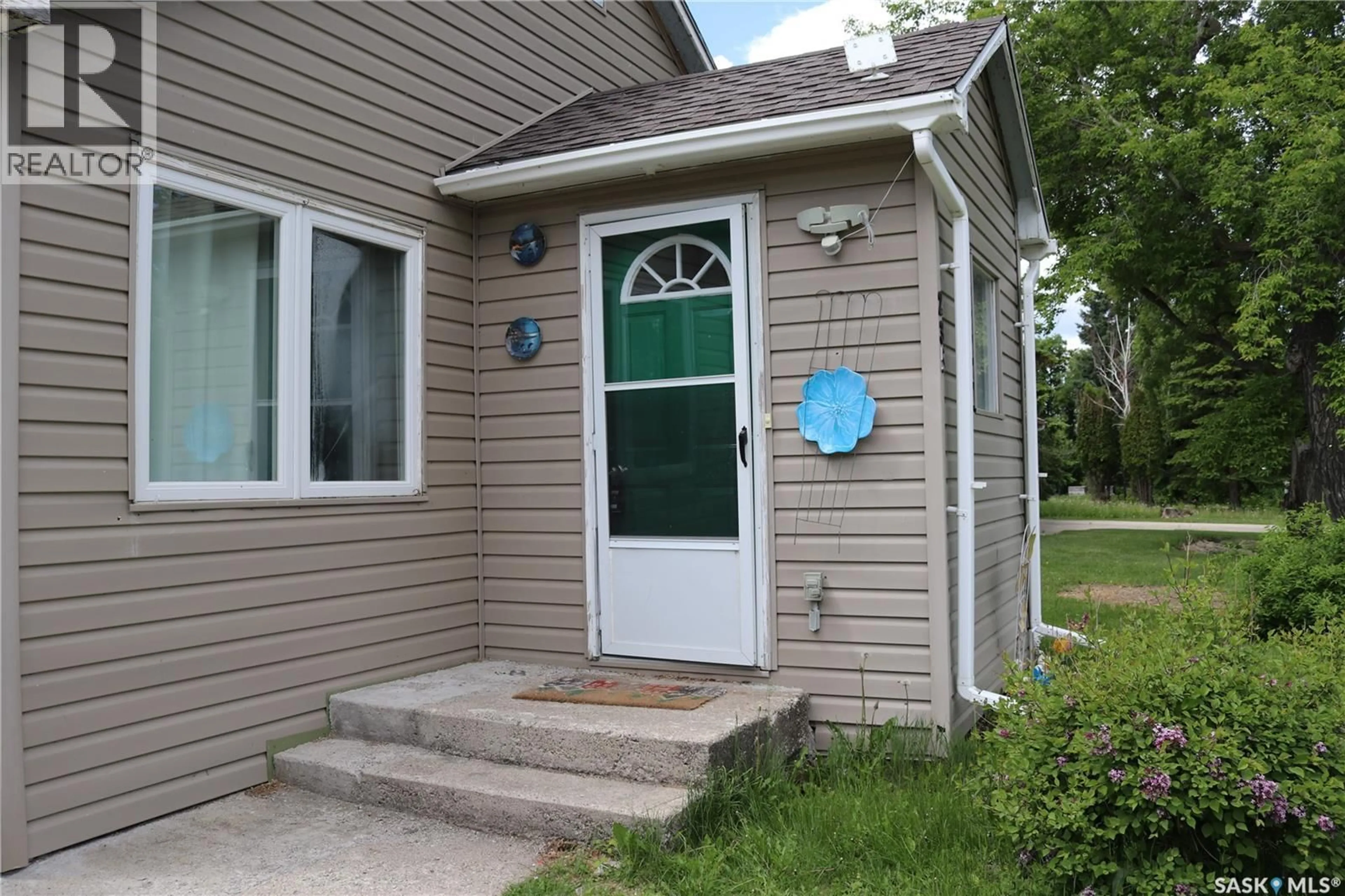 Home with vinyl exterior material, street for 235 GILBERT STREET, Drake Saskatchewan S0K1H0