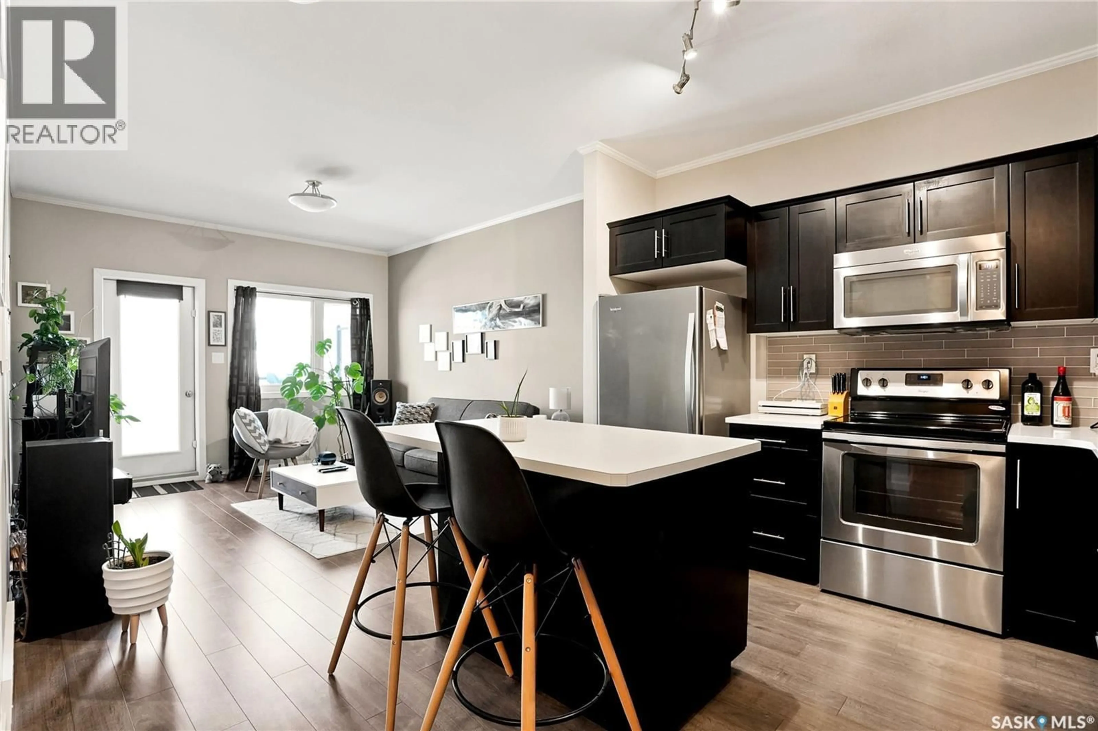 Open concept kitchen, wood/laminate floor for 103 - 720 BALTZAN BOULEVARD, Saskatoon Saskatchewan S7W0W6