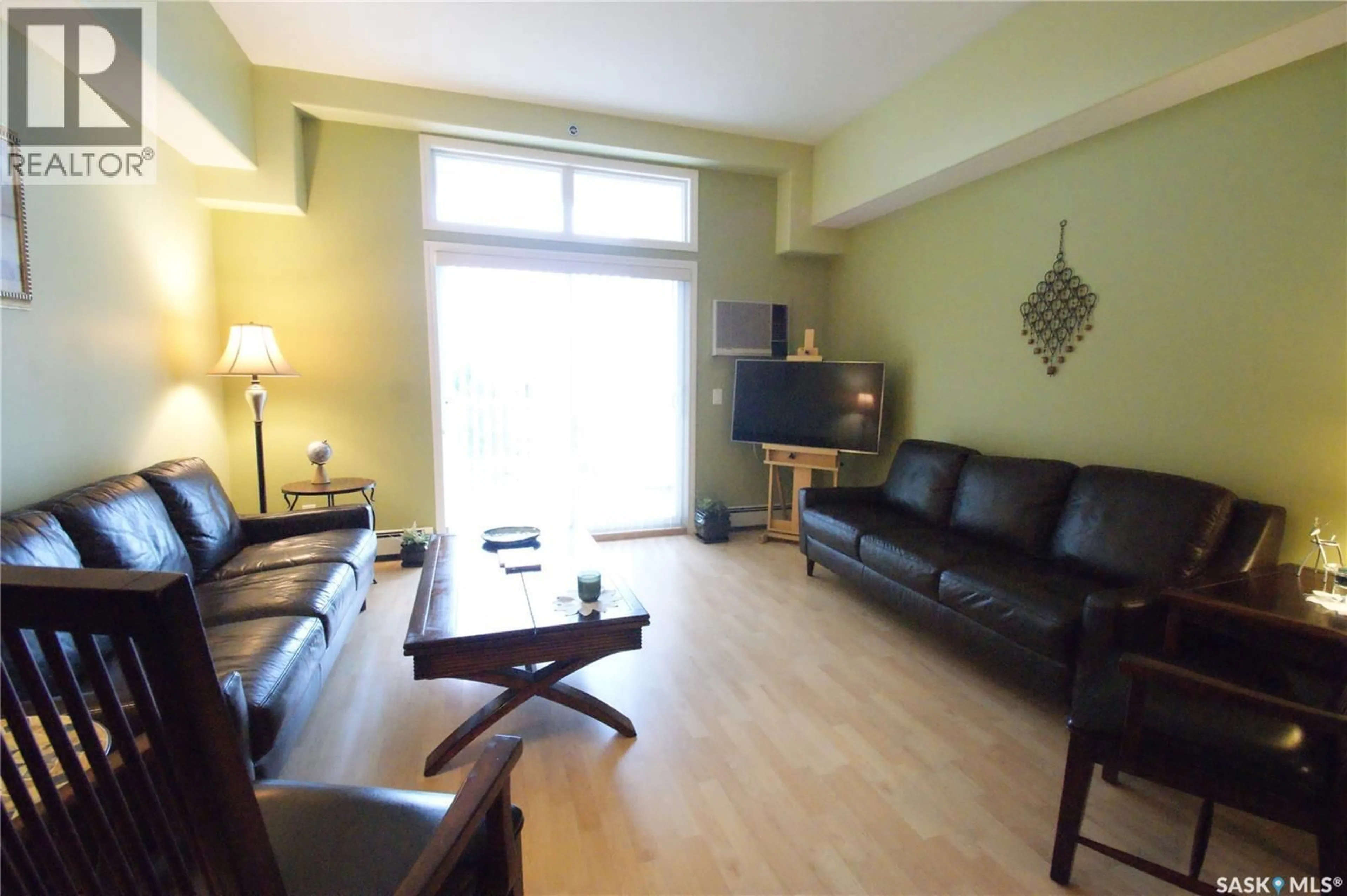 Living room with furniture, wood/laminate floor for 302 - 411 NELSON ROAD, Saskatoon Saskatchewan S7S1N9