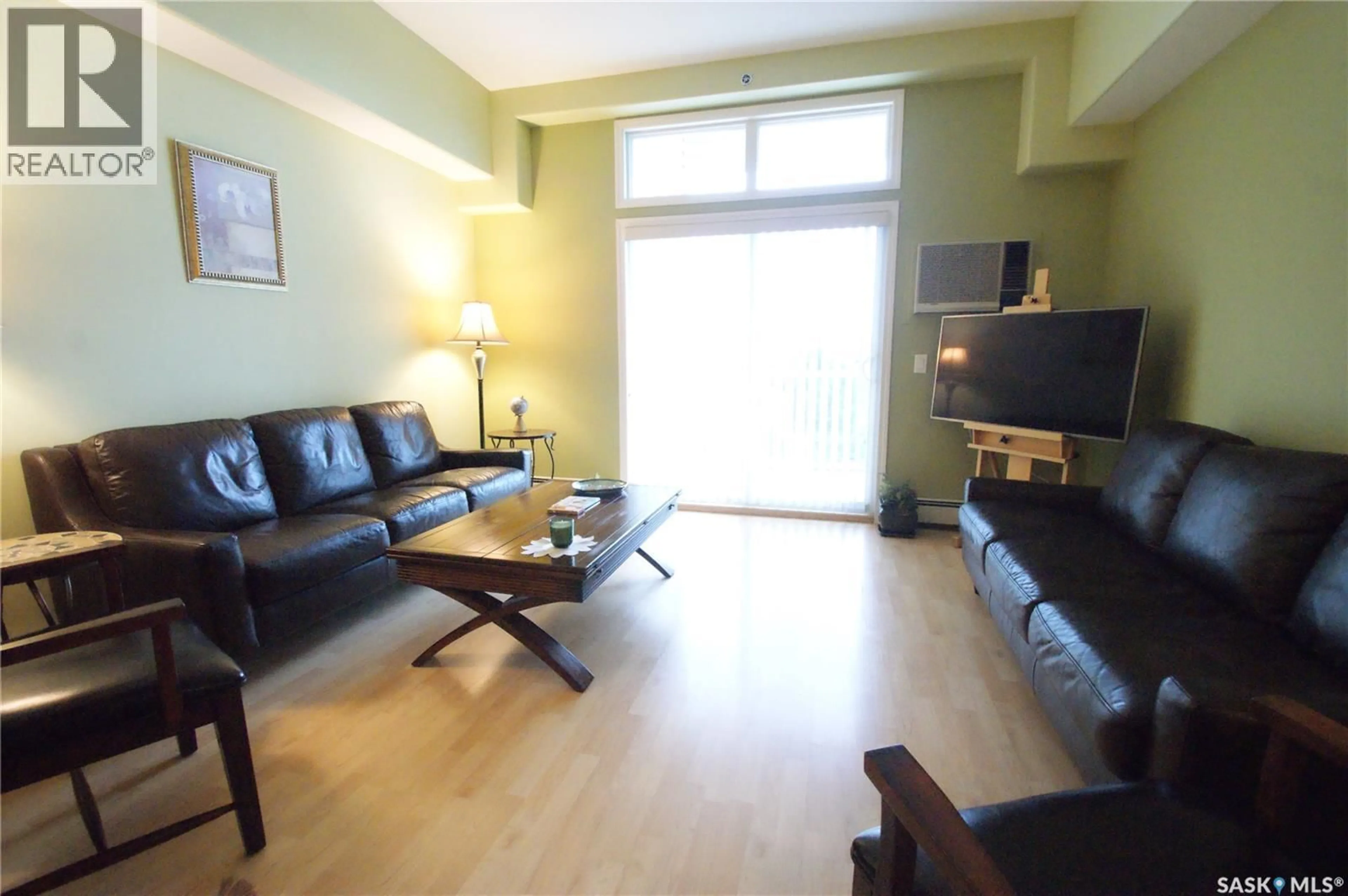 Living room with furniture, wood/laminate floor for 302 - 411 NELSON ROAD, Saskatoon Saskatchewan S7S1N9