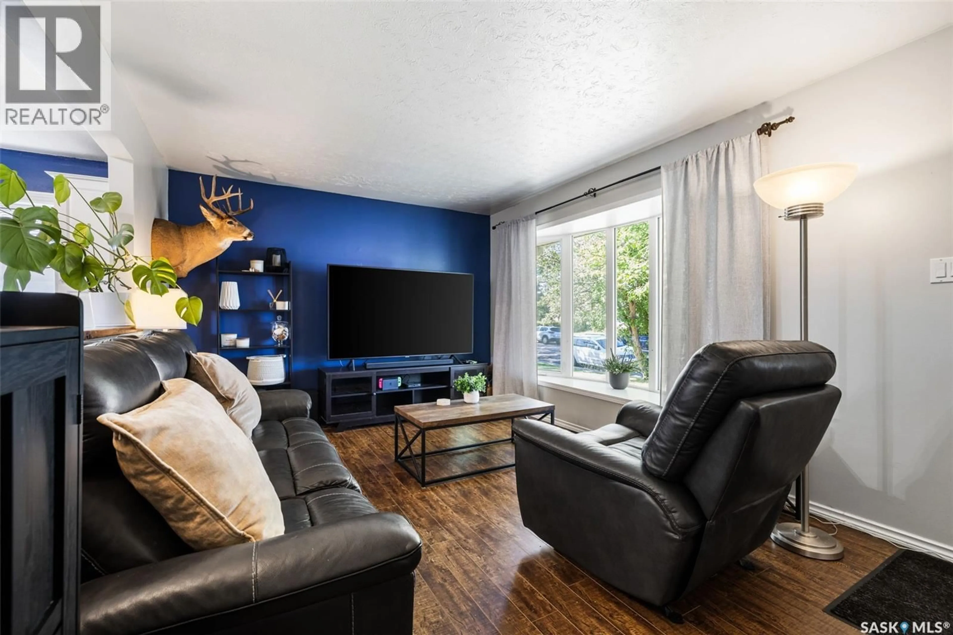 Living room with furniture, wood/laminate floor for 261 CORNWALL STREET, Regina Saskatchewan S4R2G5