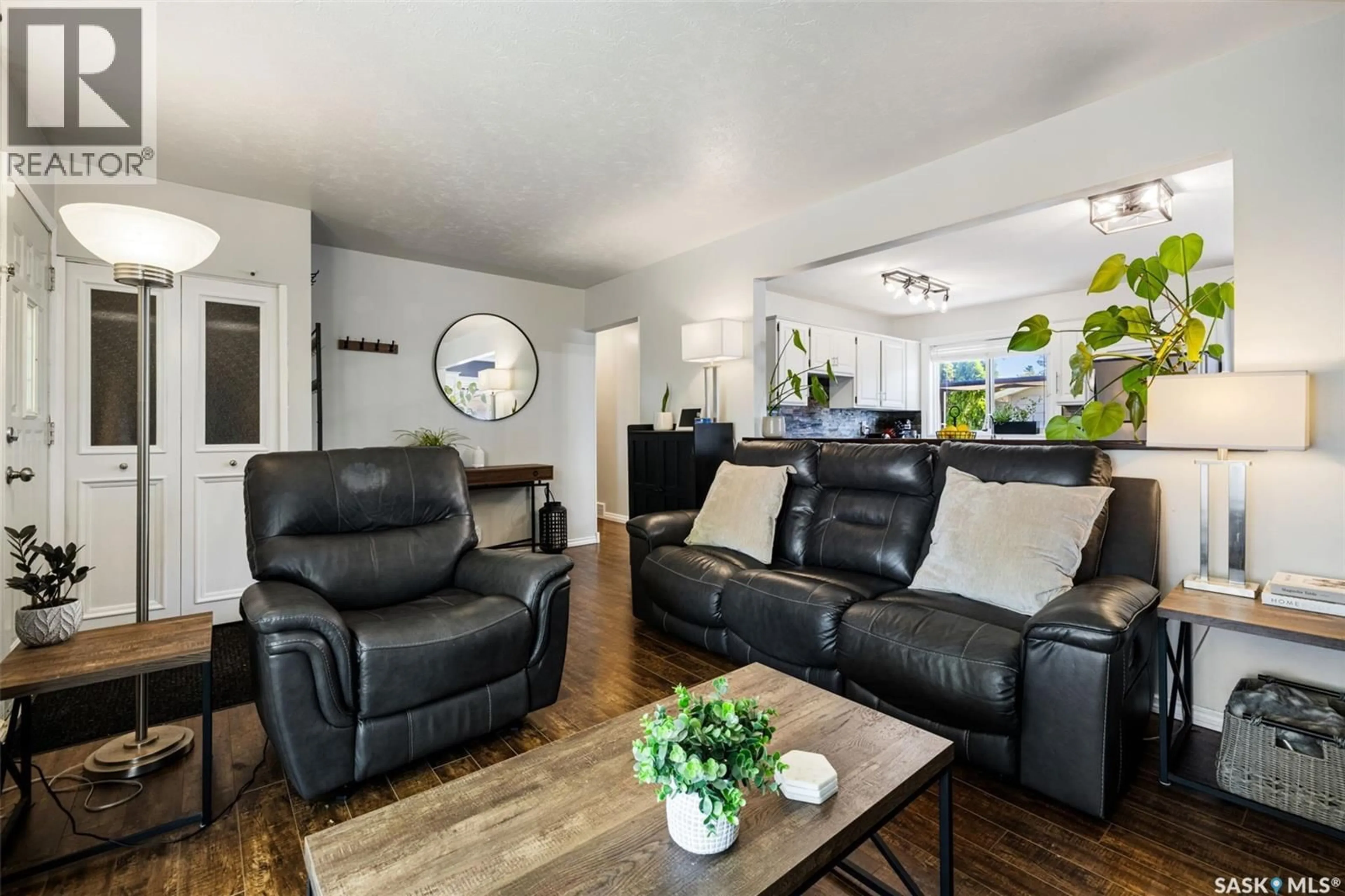 Living room with furniture, wood/laminate floor for 261 CORNWALL STREET, Regina Saskatchewan S4R2G5
