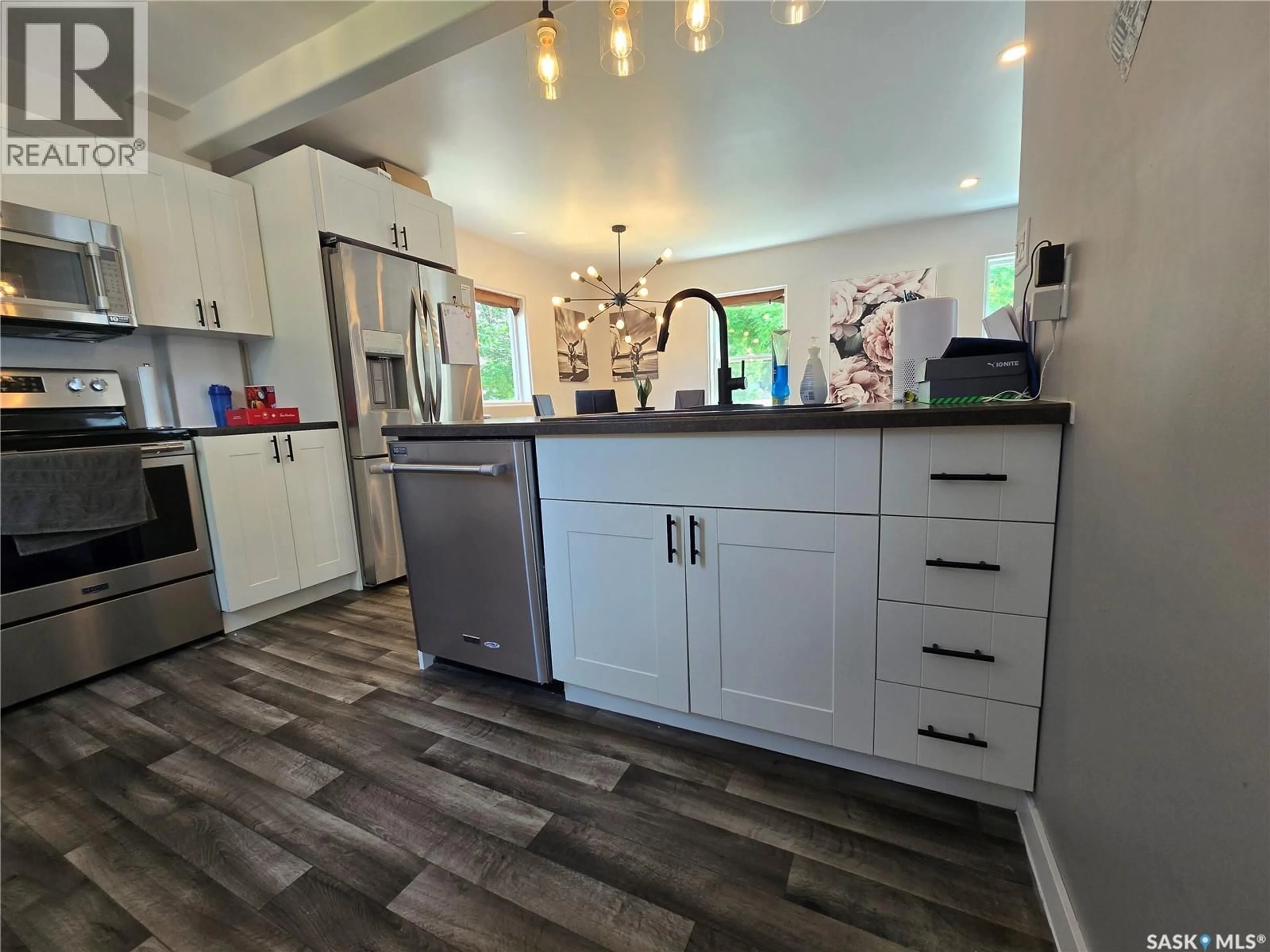 Open concept kitchen, wood/laminate floor for 107 9TH AVENUE, Weyburn Saskatchewan S4H1Z6