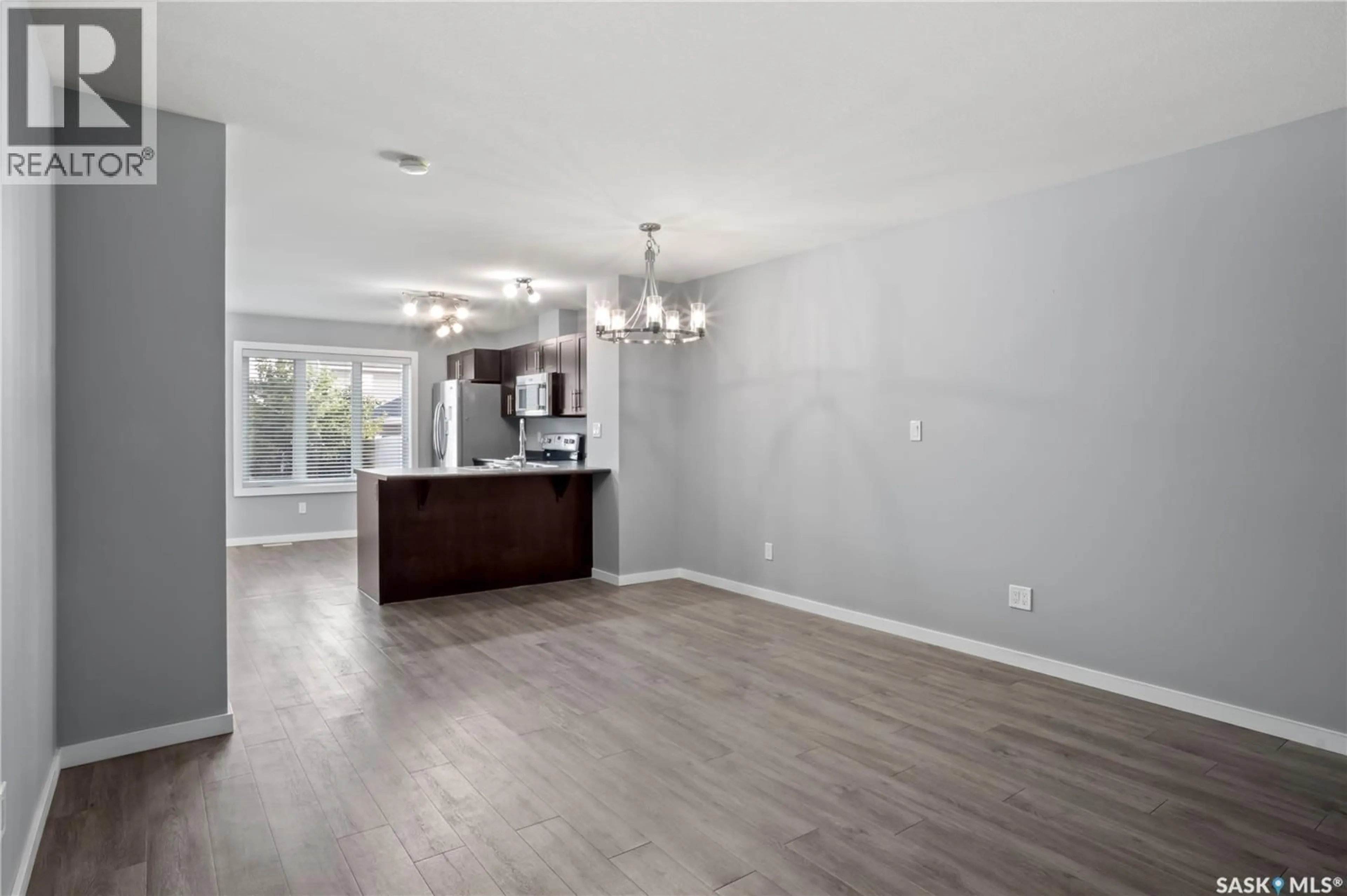 Open concept kitchen, wood/laminate floor for E - 4533 PRIMROSE GREEN DRIVE, Regina Saskatchewan S4V3K4