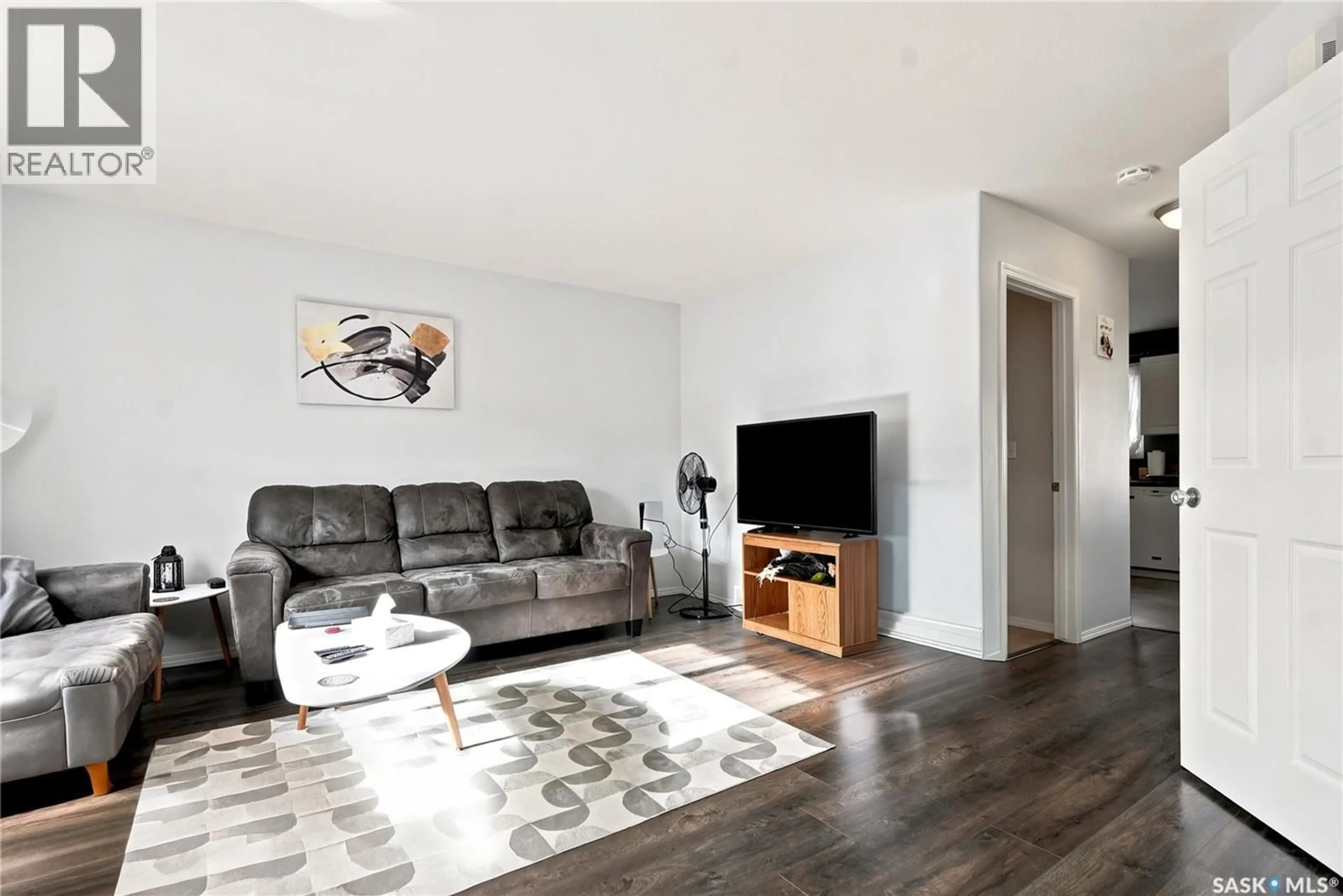 Living room with furniture, wood/laminate floor for 8 203 HEROLD TERRACE, Saskatoon Saskatchewan S7V1H4