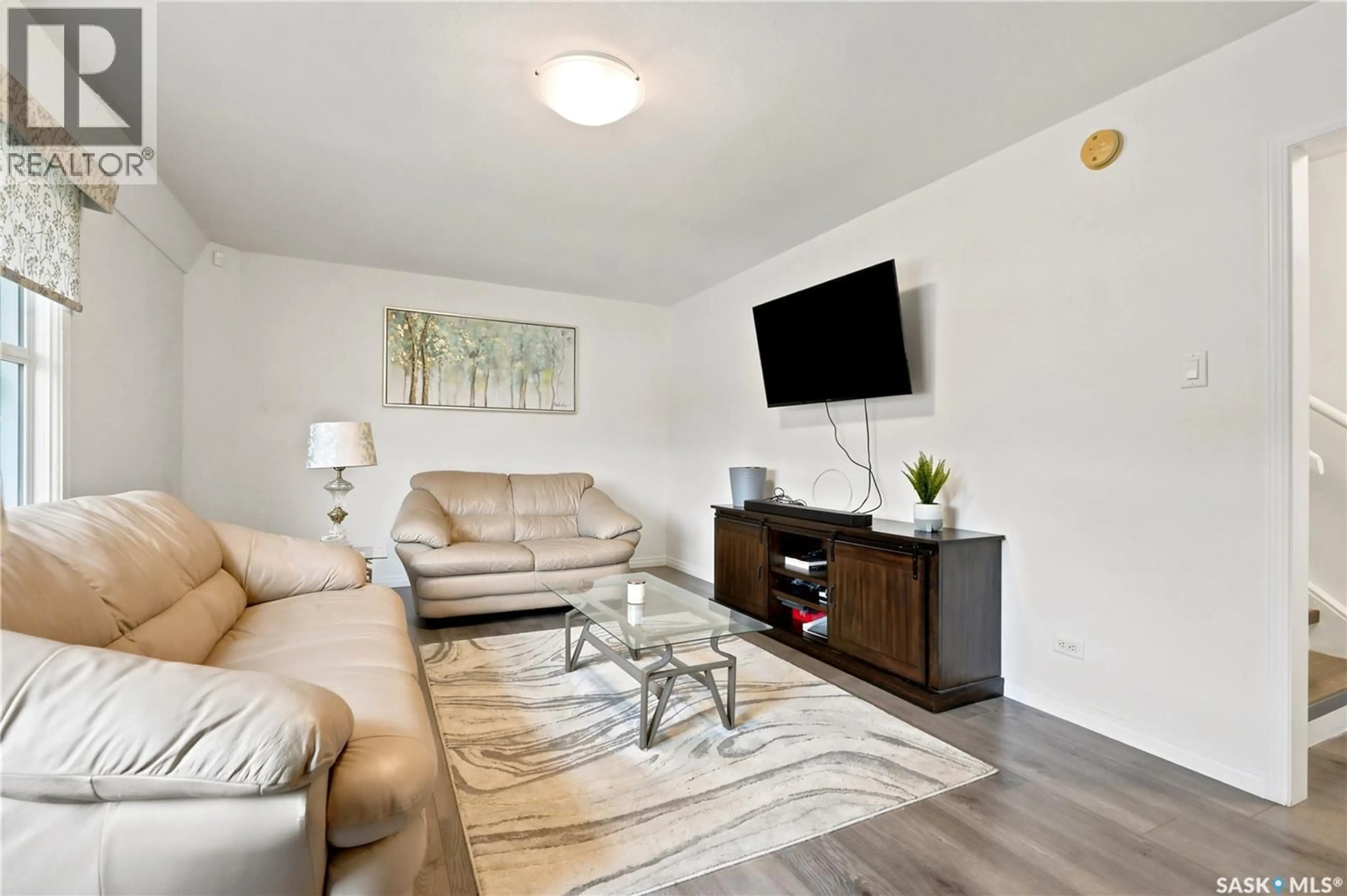 Living room with furniture, wood/laminate floor for 36 210 CAMPONI PLACE, Saskatoon Saskatchewan S7M1J7