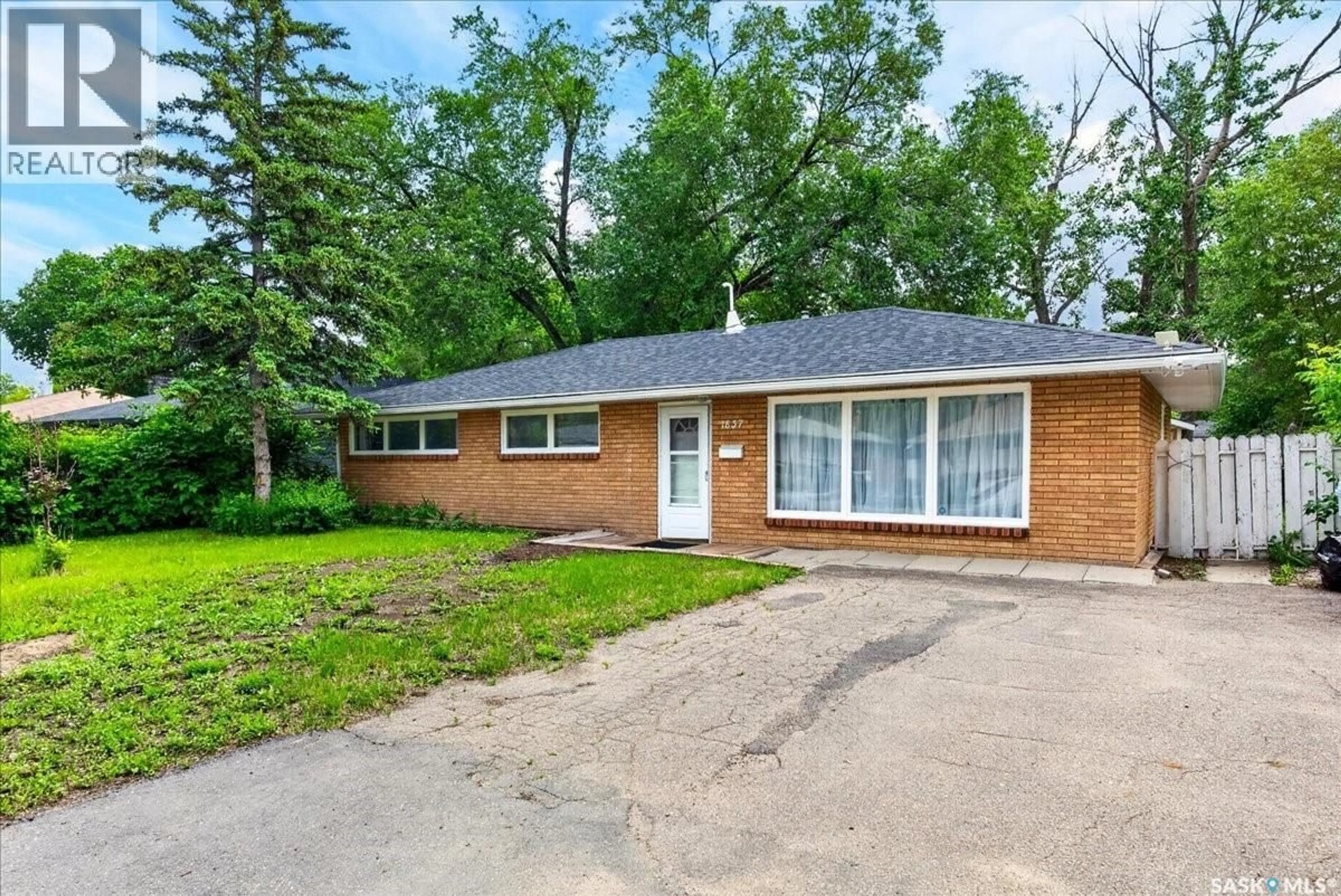 Home with brick exterior material, street for 1837 GRANT DRIVE, Regina Saskatchewan S4S4V5