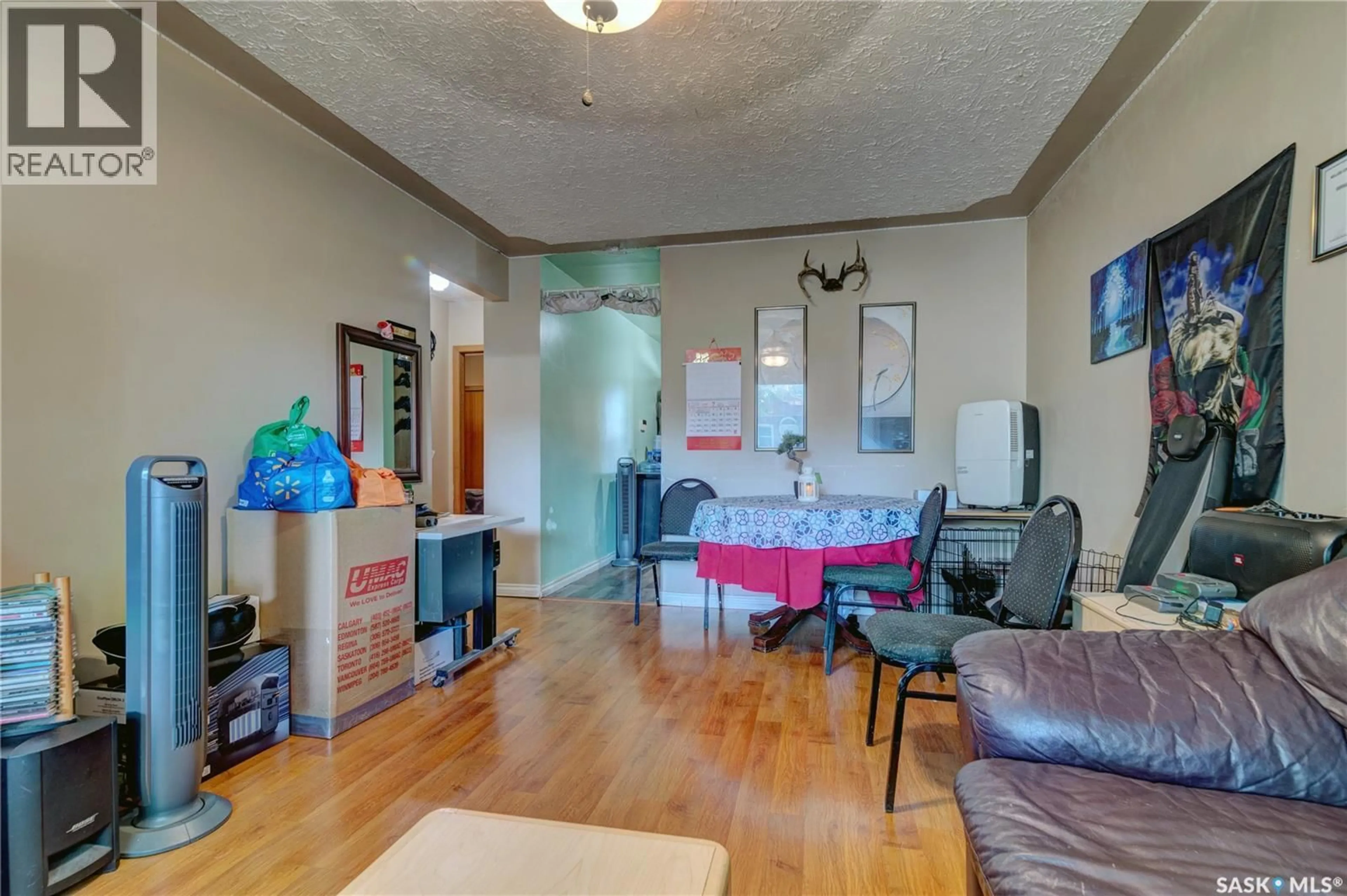 Living room with furniture, wood/laminate floor for 1745 QUEBEC STREET, Regina Saskatchewan S4P1J4