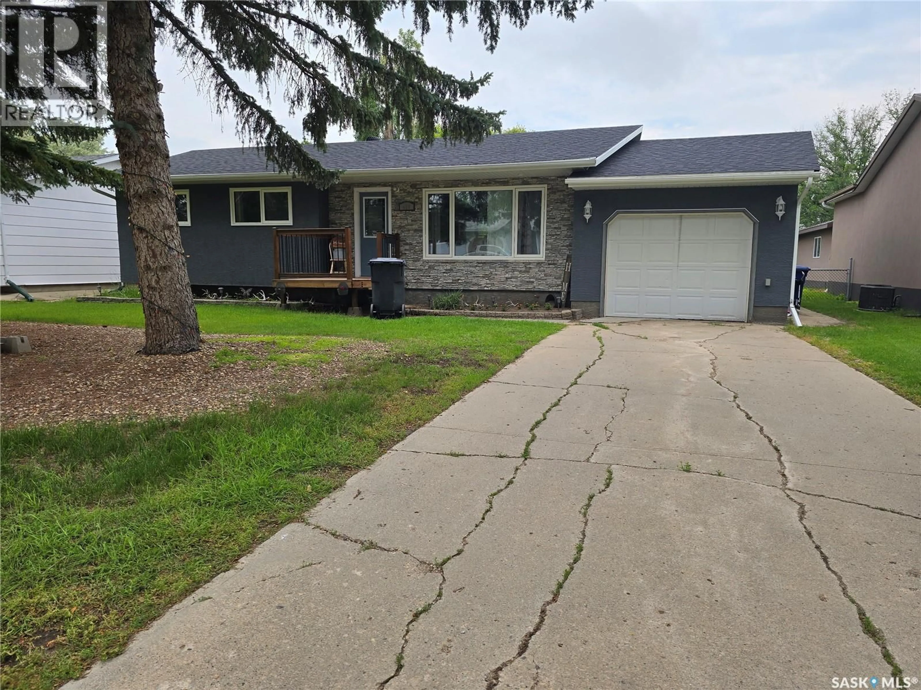 Home with vinyl exterior material, street for 619 BRIMACOMBE DRIVE, Weyburn Saskatchewan S4H2P3