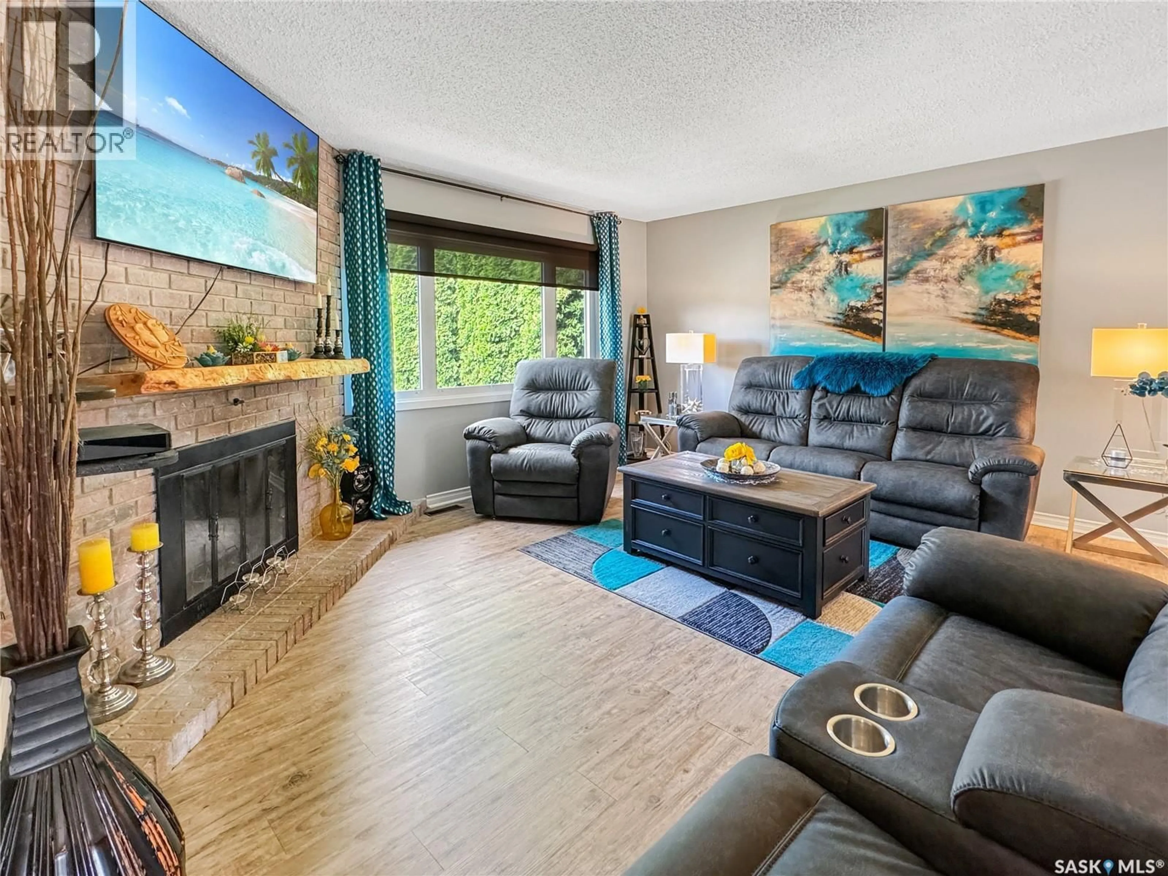 Living room with furniture, wood/laminate floor for 1772 CENTENNIAL CRESCENT, North Battleford Saskatchewan S9A3J3