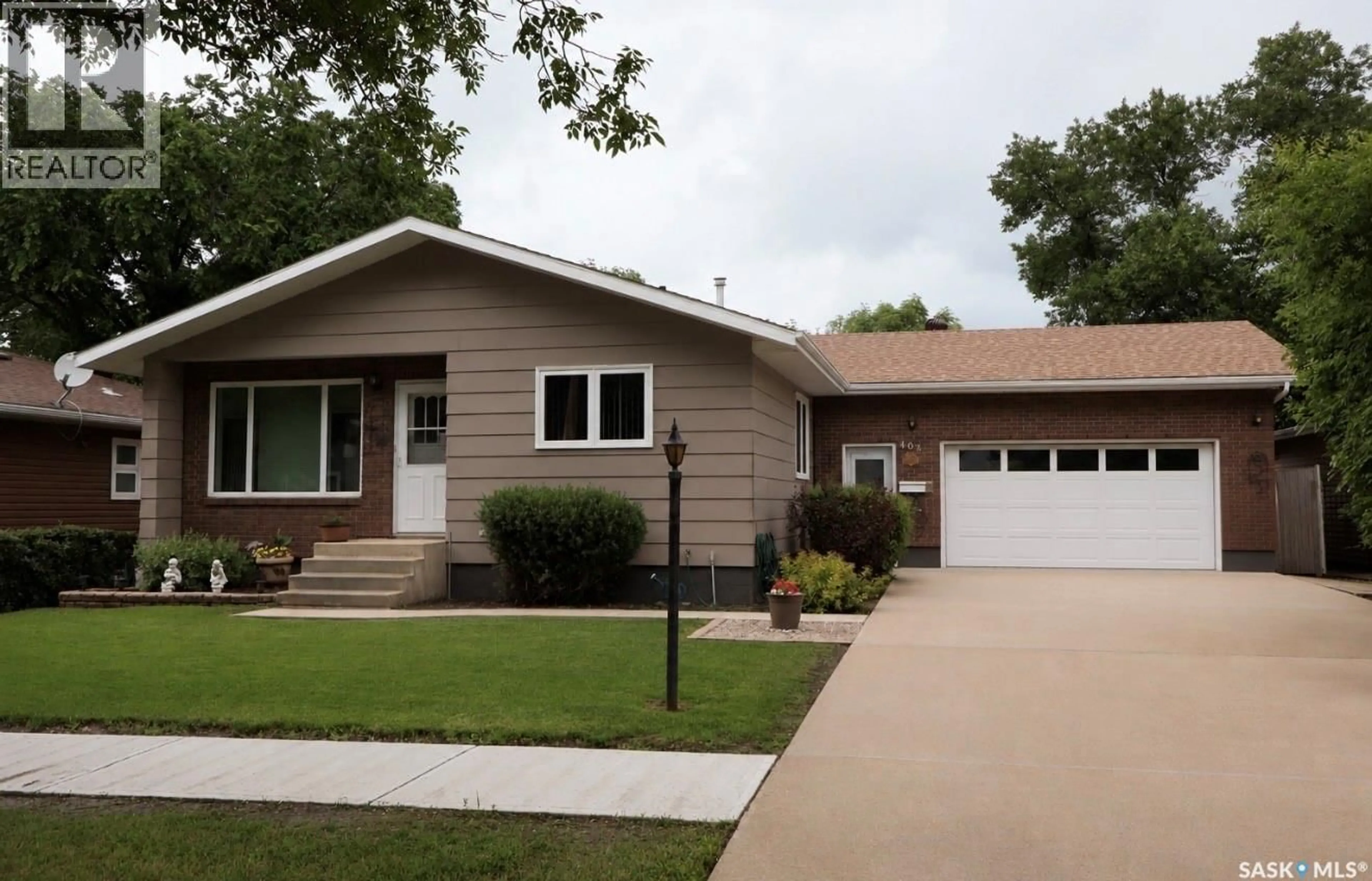 Home with vinyl exterior material, street for 407 7TH AVENUE, Assiniboia Saskatchewan S0H0B0