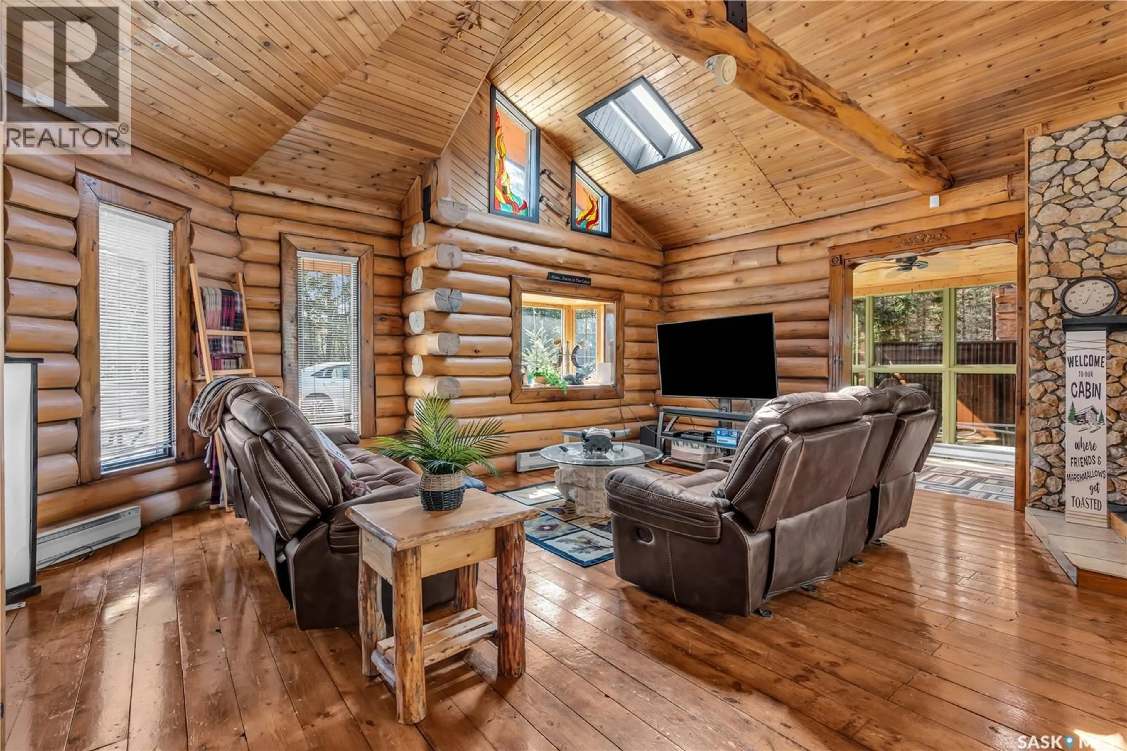Living room with furniture, wood/laminate floor for 211 AL DRIVE, Turtle Lake Saskatchewan S0M1J0