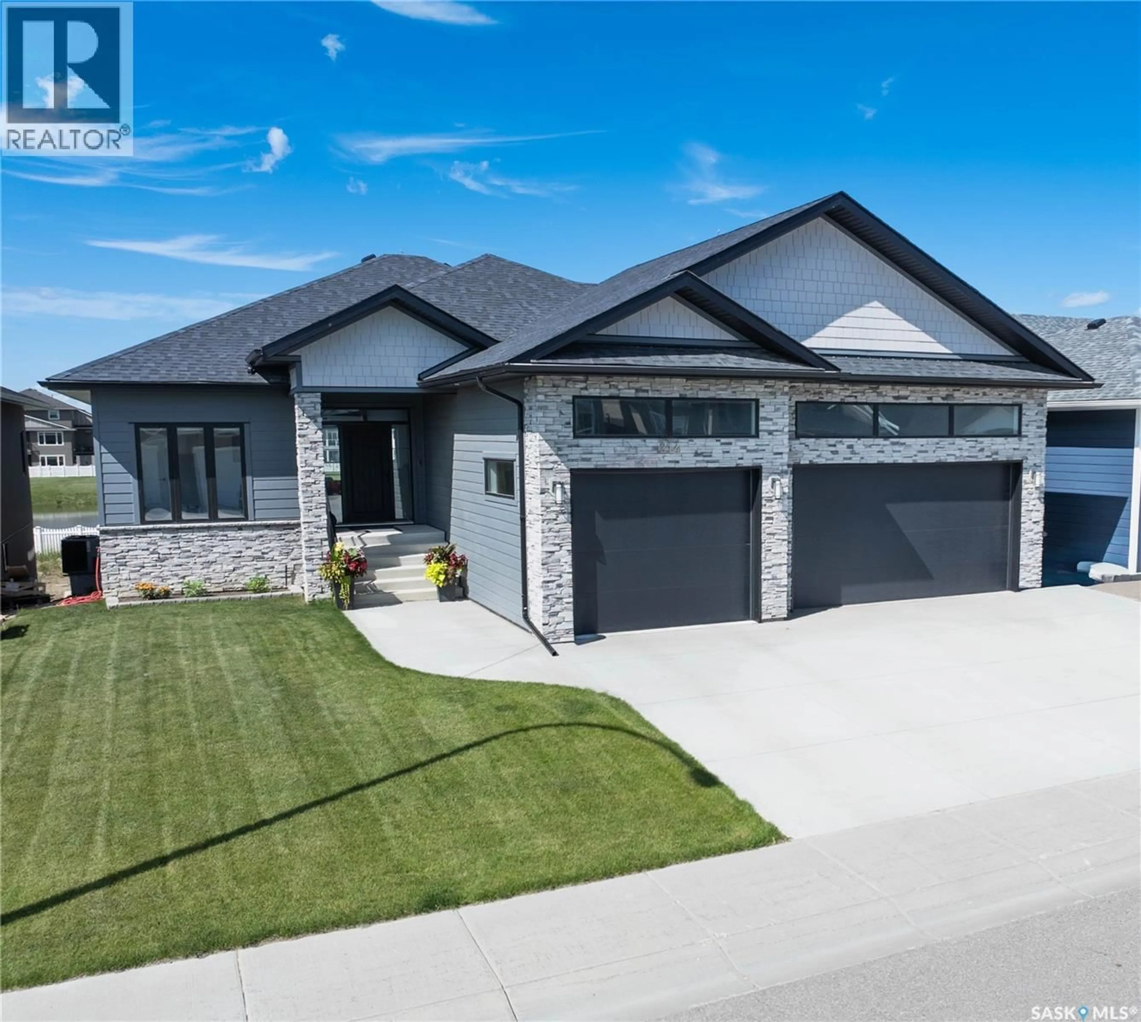 Home with brick exterior material, street for 214 SETTLER CRESCENT, Warman Saskatchewan S0K4S5