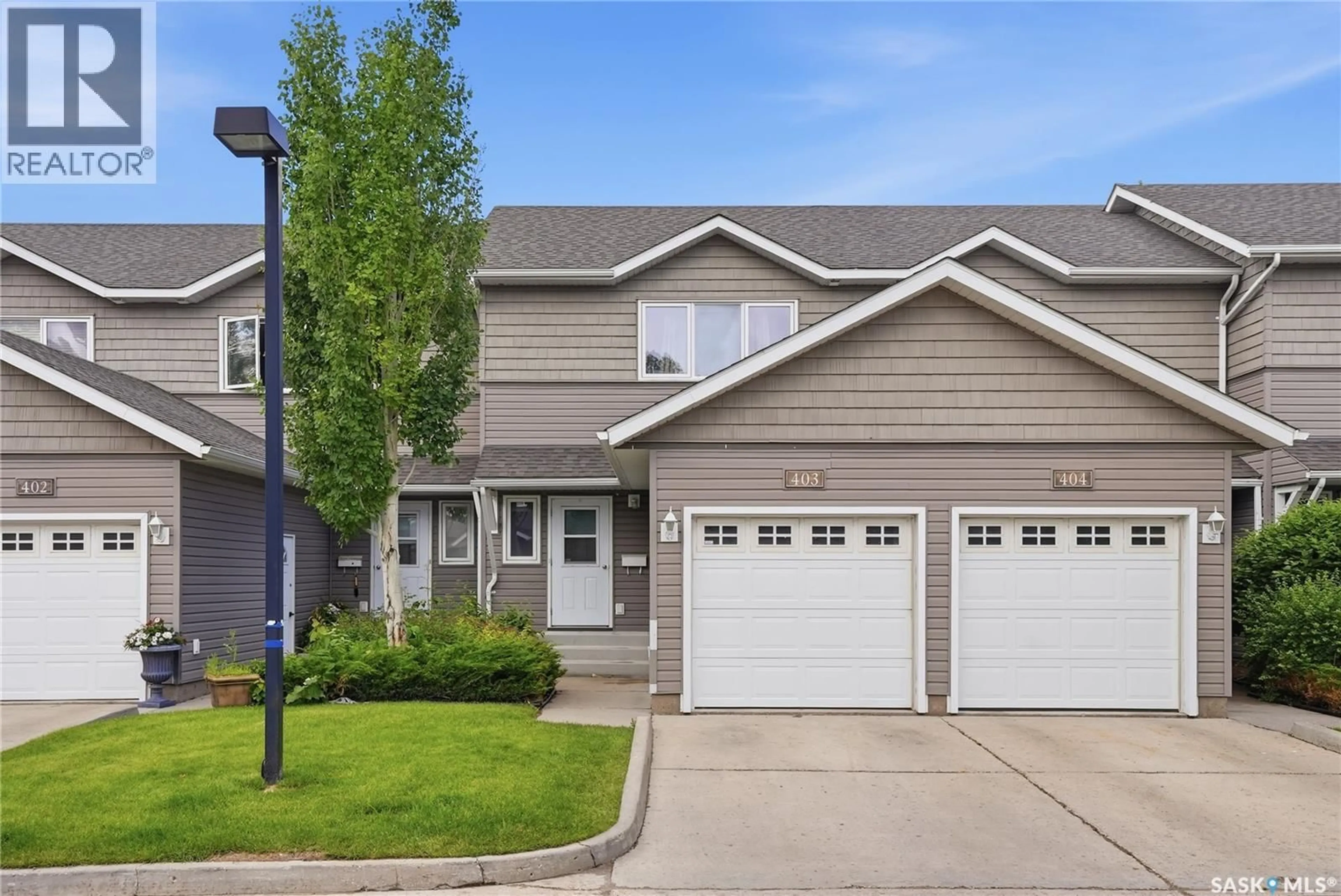Home with vinyl exterior material, street for 715 - 403 HART ROAD, Saskatoon Saskatchewan S7M3Y7