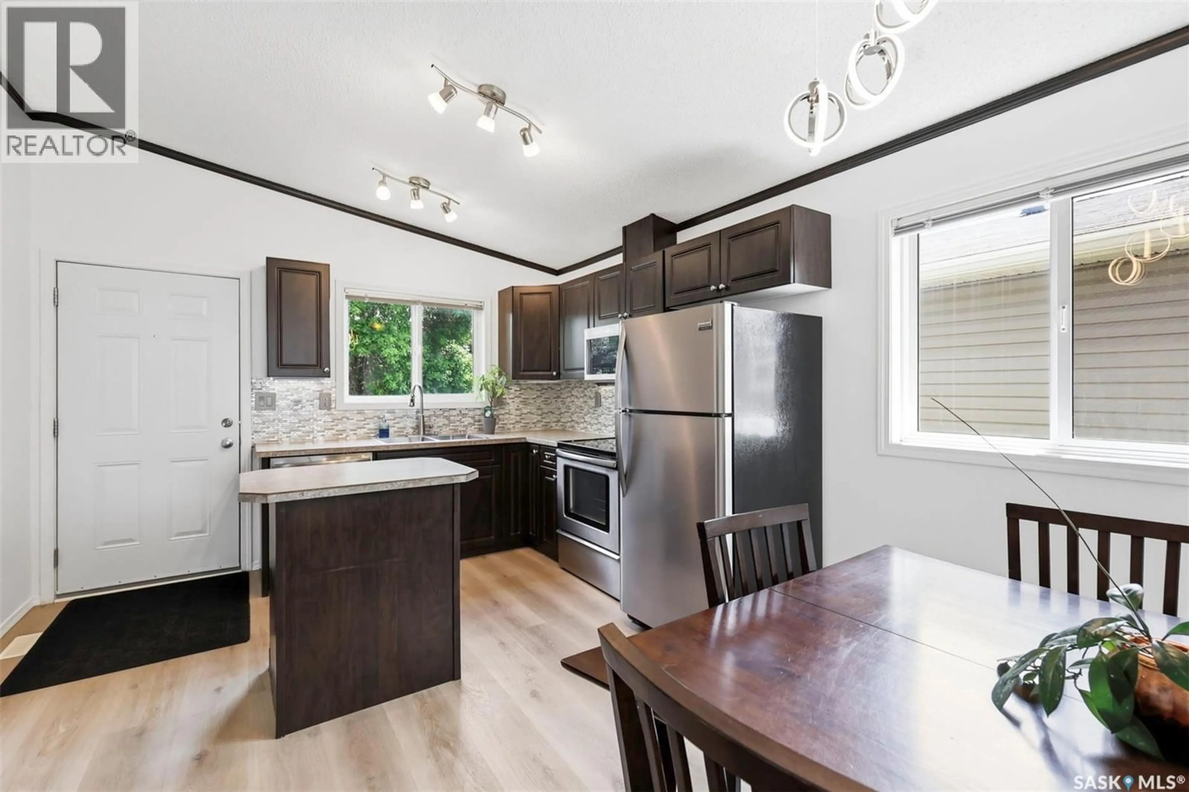 Open concept kitchen, wood/laminate floor for 55 - 26 BORDEN CRESCENT, Saskatoon Saskatchewan S7L5J9