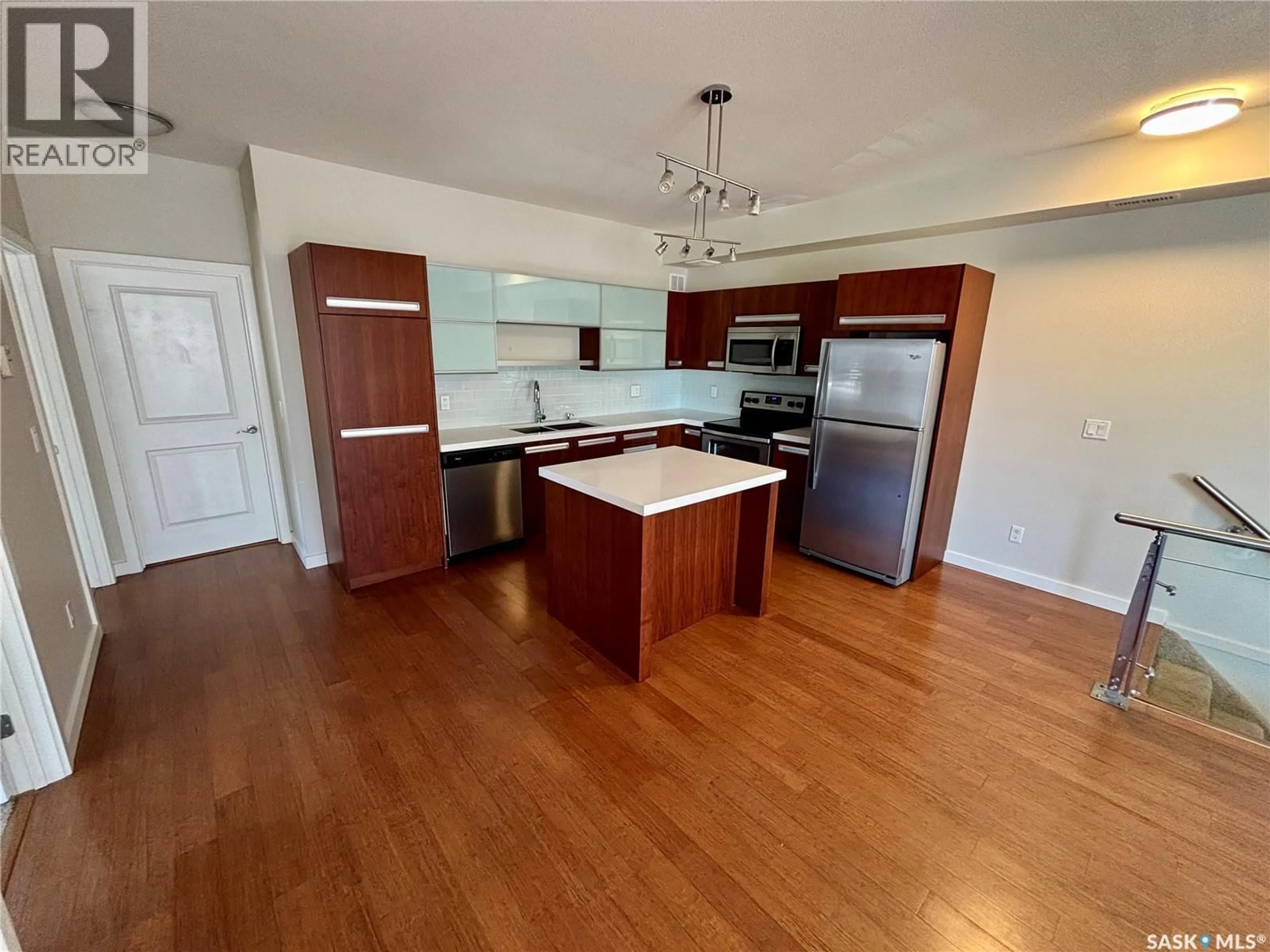 Open concept kitchen, wood/laminate floor for 1015 - 2110 PATRICK CRESCENT, Saskatoon Saskatchewan S7W0M2