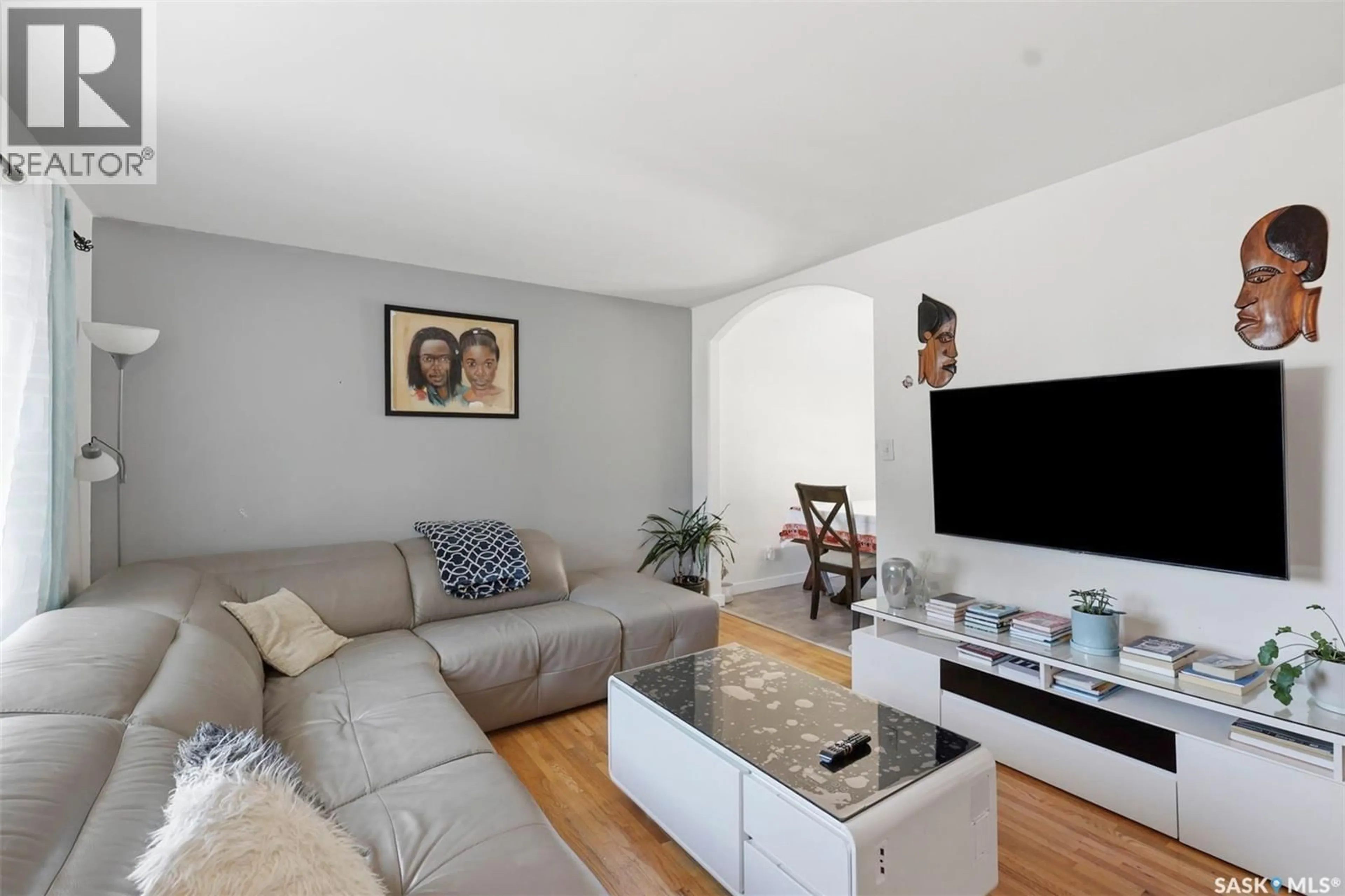 Living room with furniture, wood/laminate floor for 123 KIRKPATRICK CRESCENT, Saskatoon Saskatchewan S7L6Z1