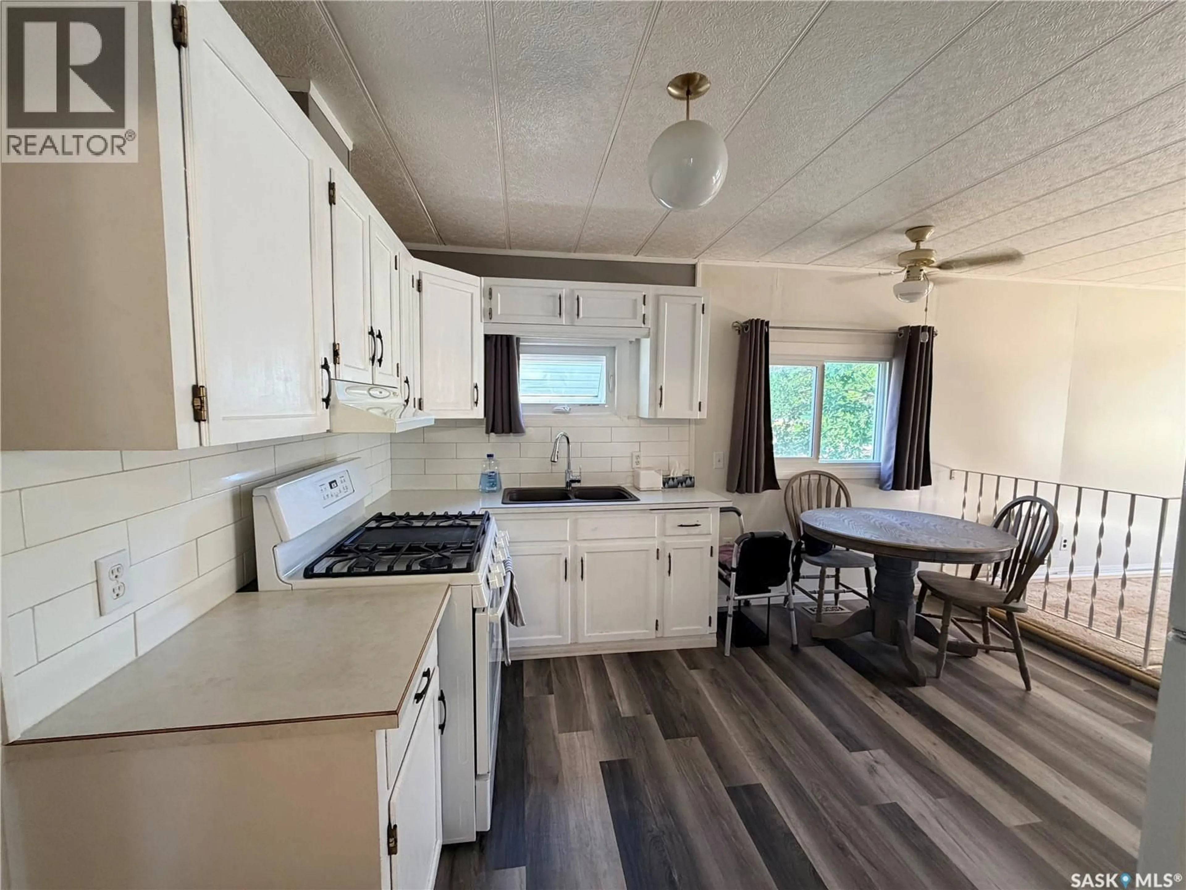 Open concept kitchen, wood/laminate floor for 25 SUNRISE ESTATES, Assiniboia Saskatchewan S0H0B0