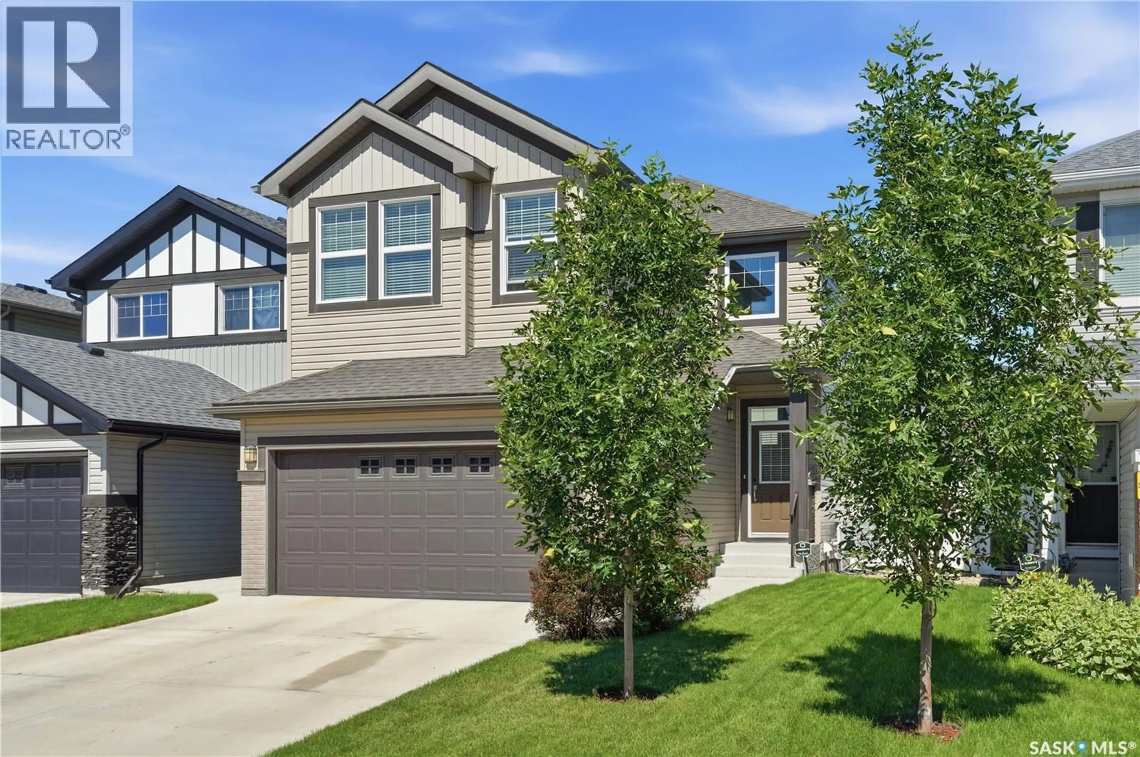 Home with brick exterior material, street for 211 DAGNONE LANE, Saskatoon Saskatchewan S7V0R1
