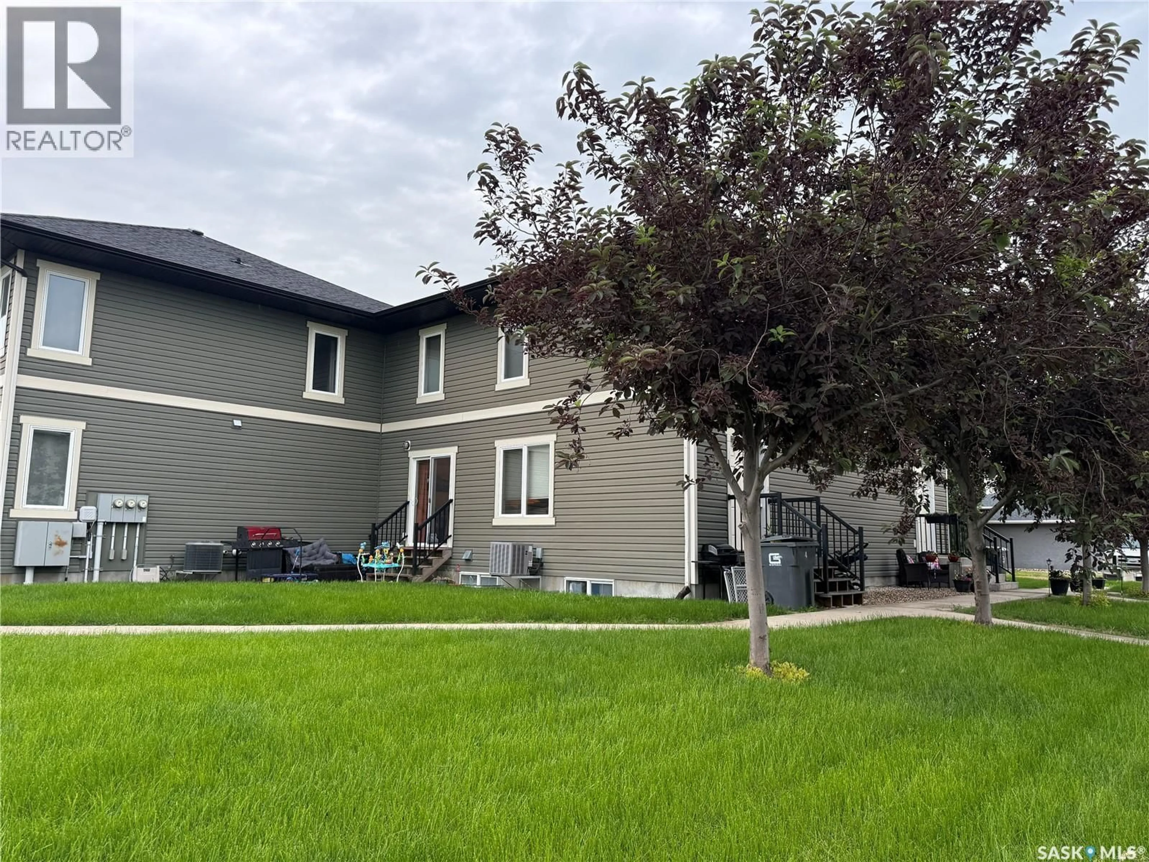 A pic from outside/outdoor area/front of a property/back of a property/a pic from drone, unknown for 4 1795 CLARK AVENUE, Weyburn Saskatchewan S4H3L3