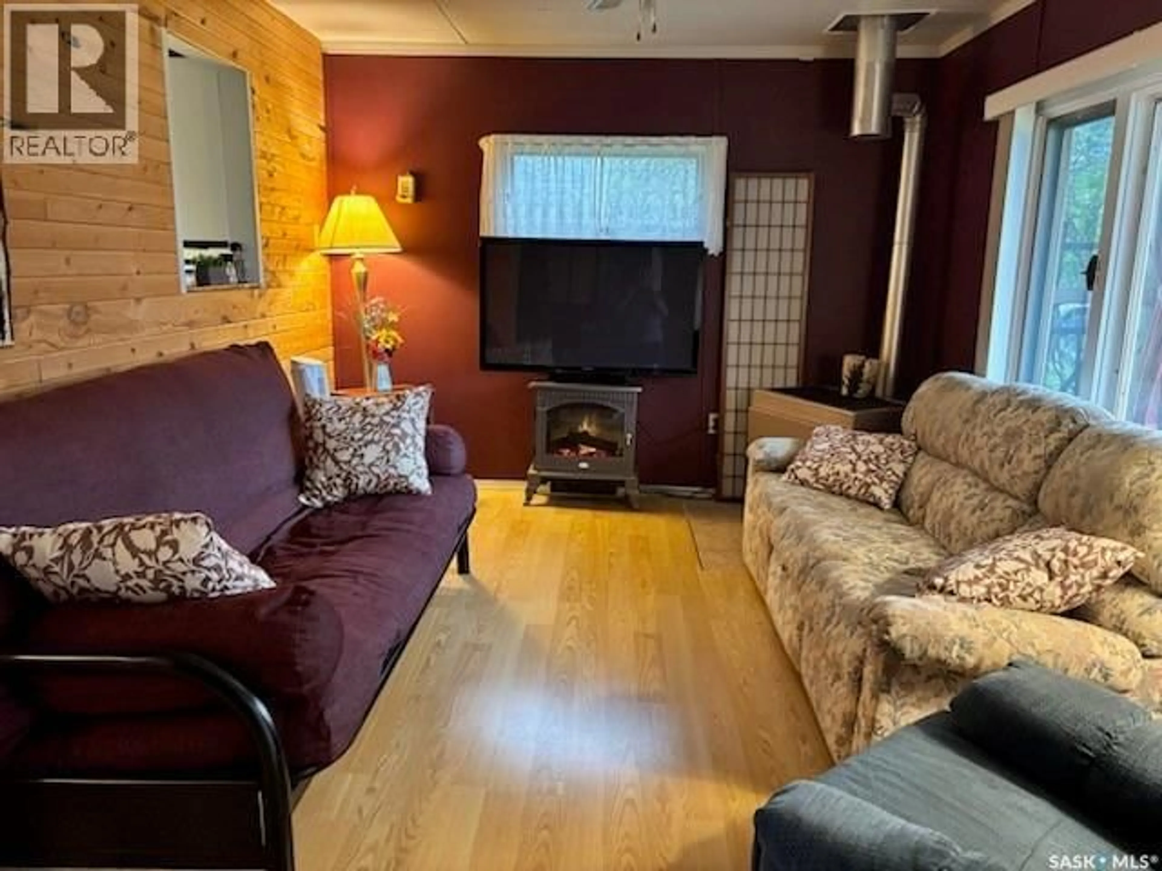 Living room with furniture, wood/laminate floor for 113 FOSTER STREET, Emma Lake Saskatchewan S0J0N0