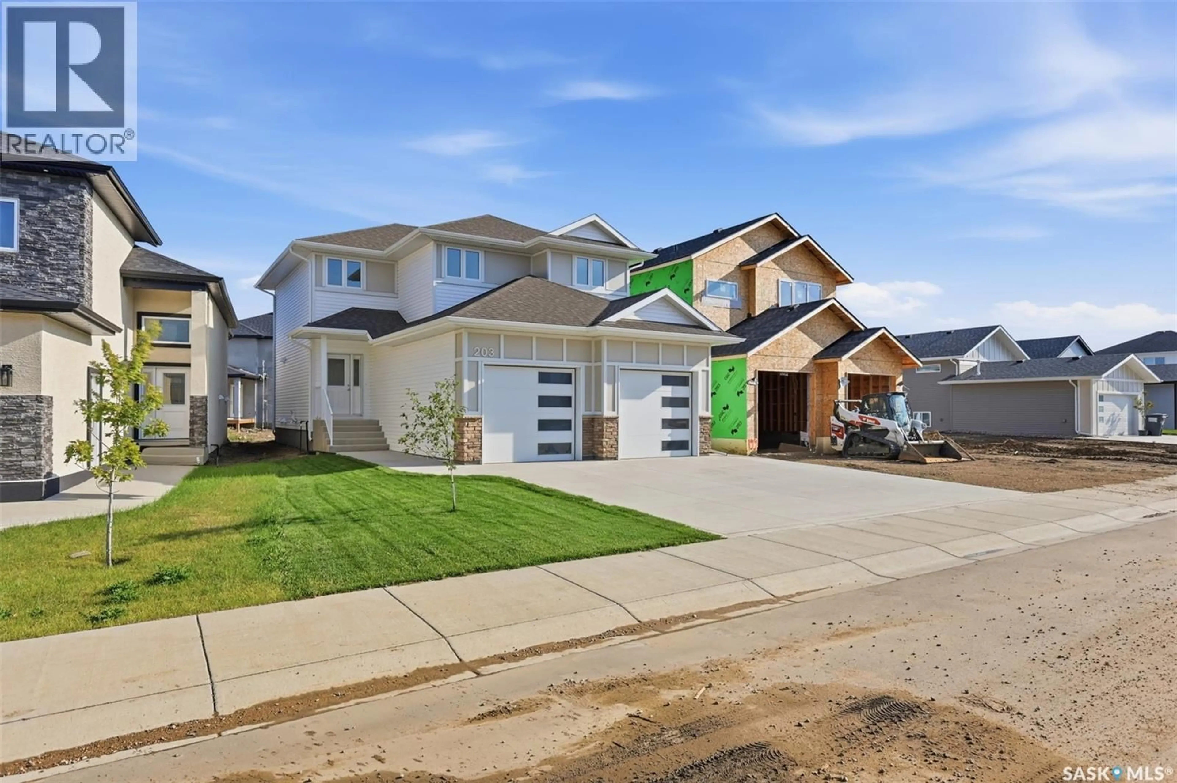 Home with vinyl exterior material, street for 203 SHARMA LANE, Saskatoon Saskatchewan S7W0Y4