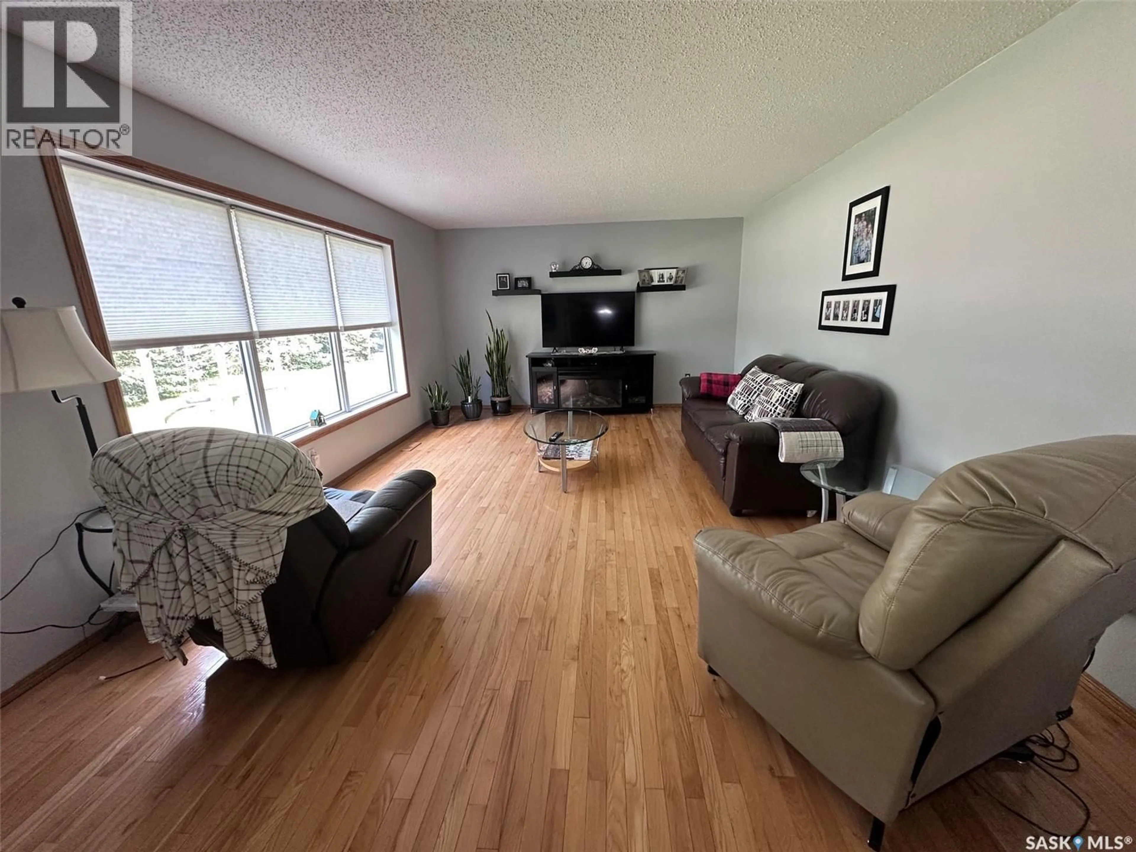 Living room with furniture, wood/laminate floor for Capasin - PEARSON ACREAGE, Spiritwood Rm No. 496 Saskatchewan S0J1N0