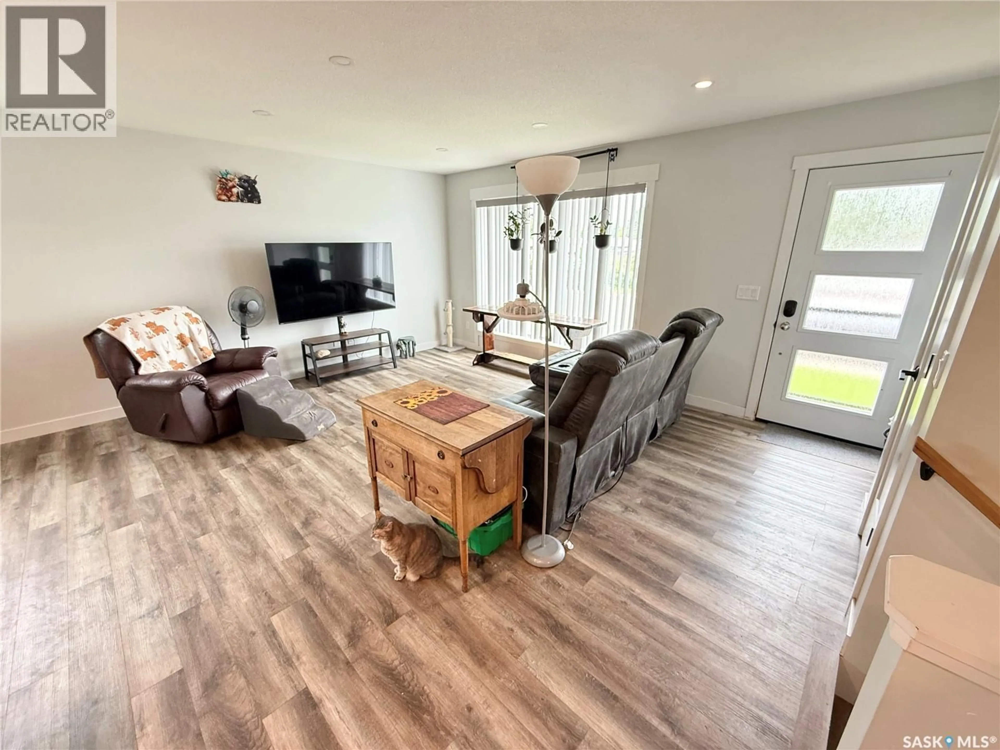 Living room with furniture, wood/laminate floor for 44 MITCHELL CRESCENT, Weyburn Saskatchewan S4H2M4