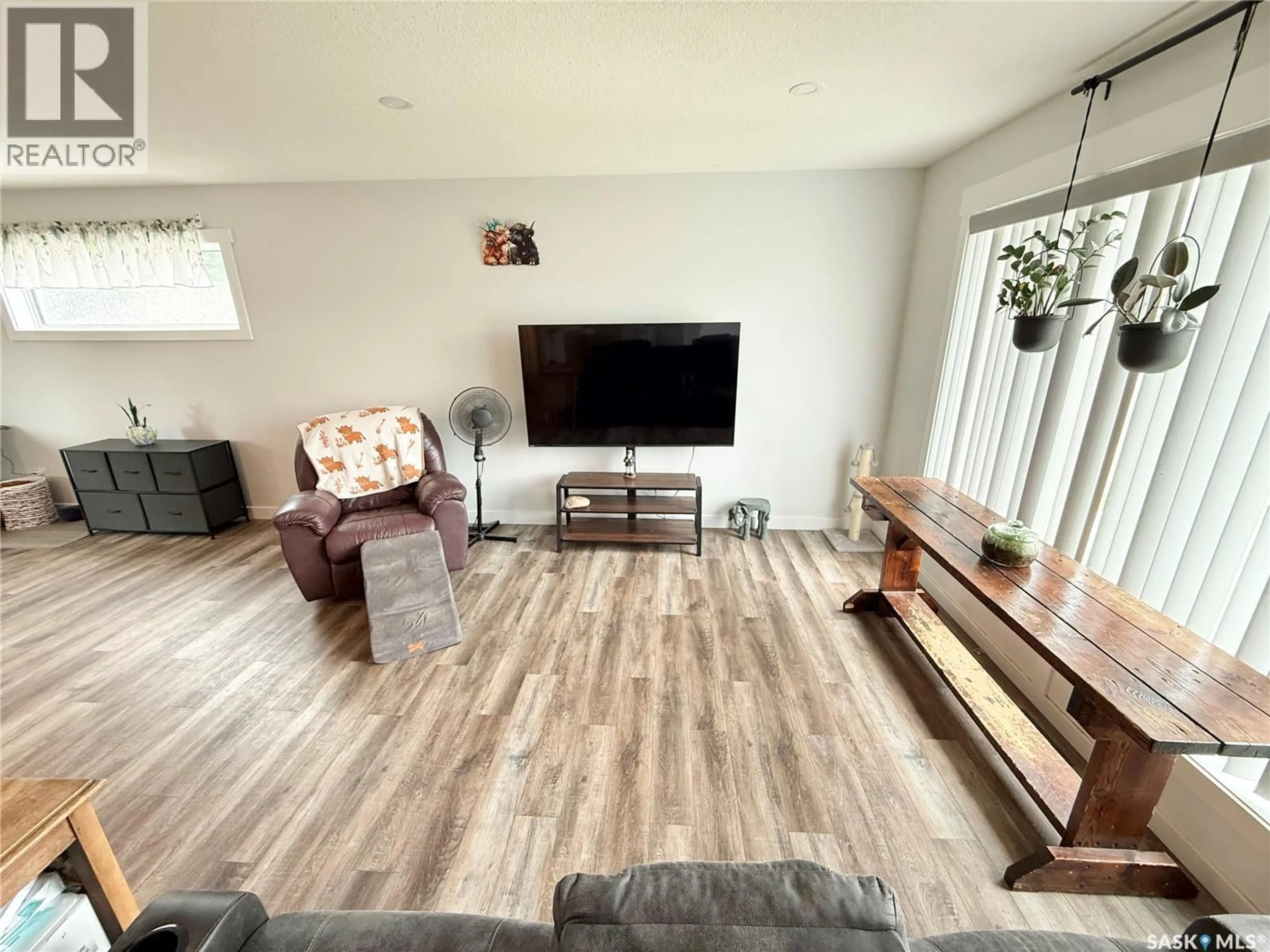 Living room with furniture, wood/laminate floor for 44 MITCHELL CRESCENT, Weyburn Saskatchewan S4H2M4