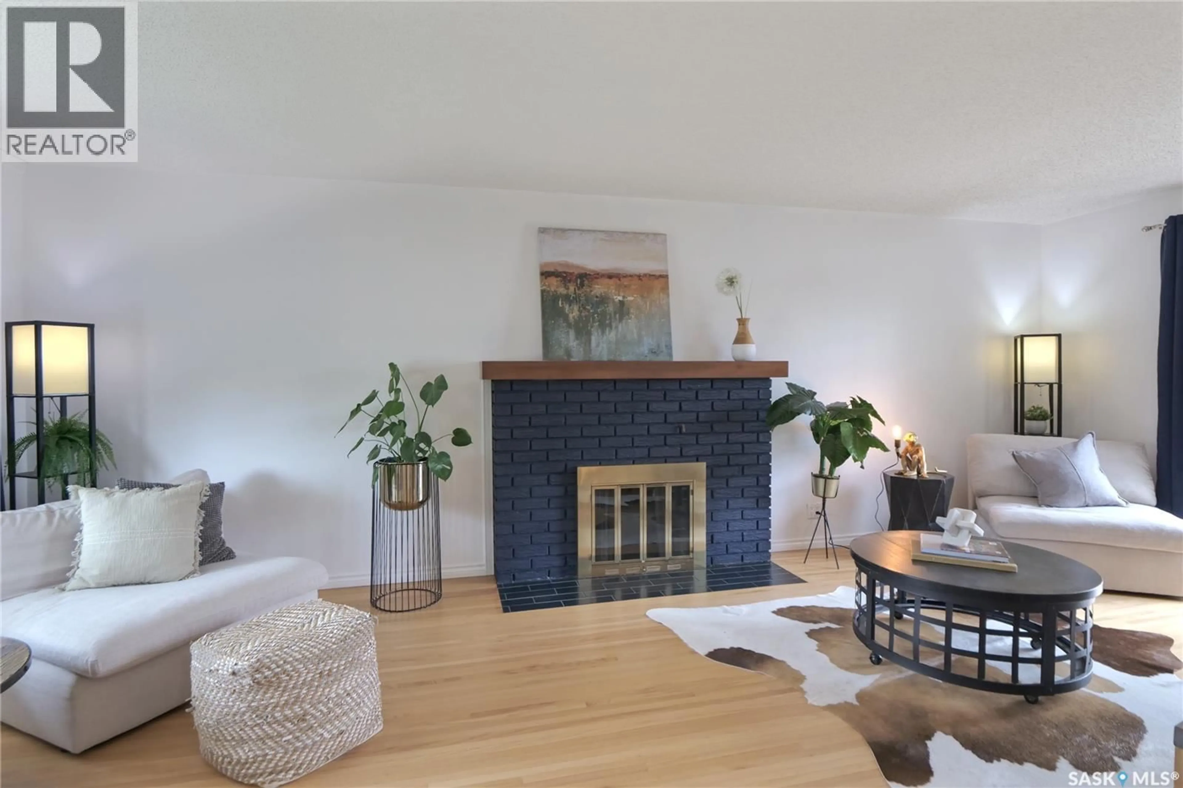Living room with furniture, wood/laminate floor for 744 SASKATCHEWAN STREET, Moose Jaw Saskatchewan S6H2T7
