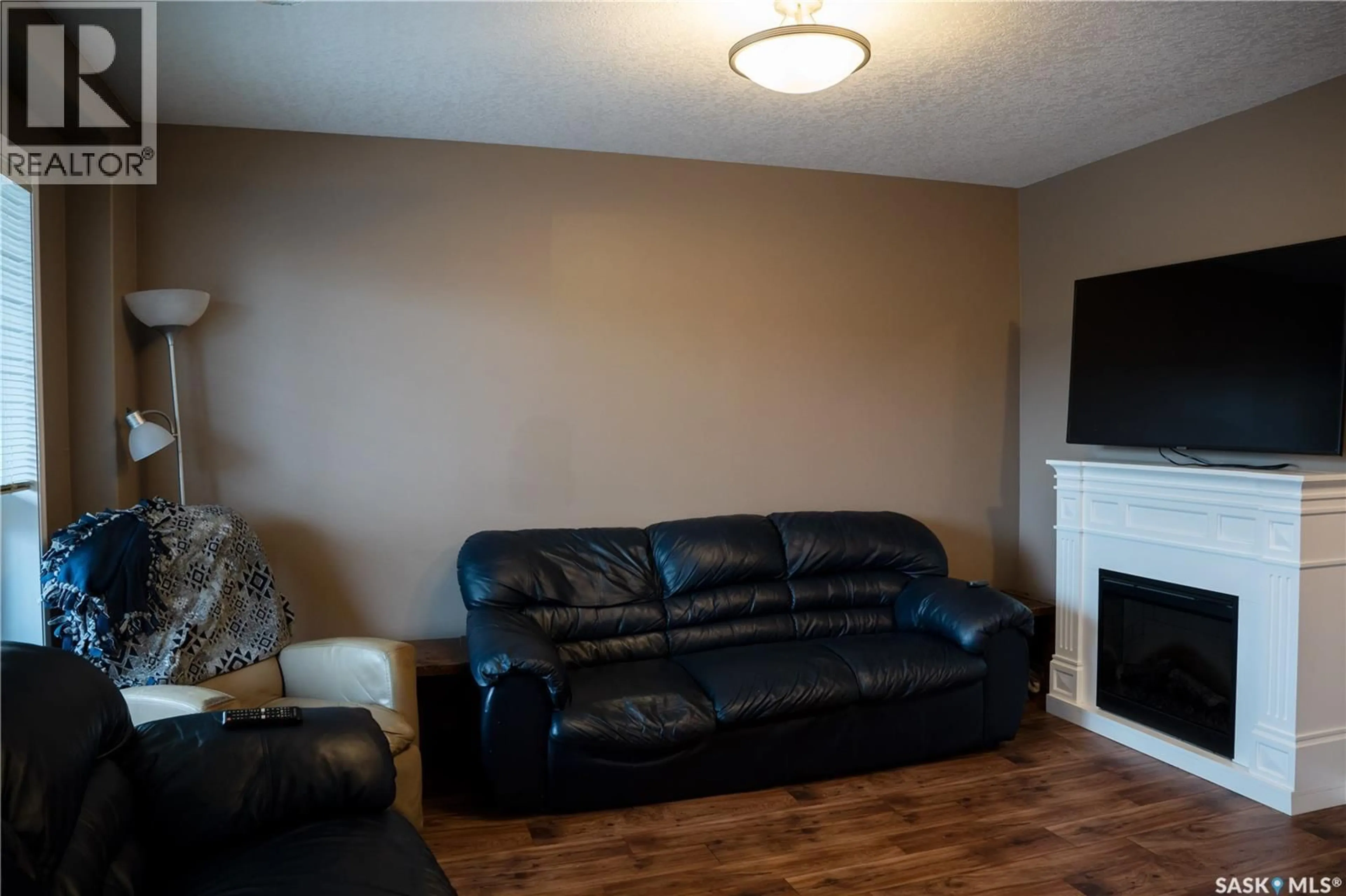 Living room with furniture, wood/laminate floor for 3806 - 714 DEWDNEY AVENUE, Regina Saskatchewan S4Z0A6