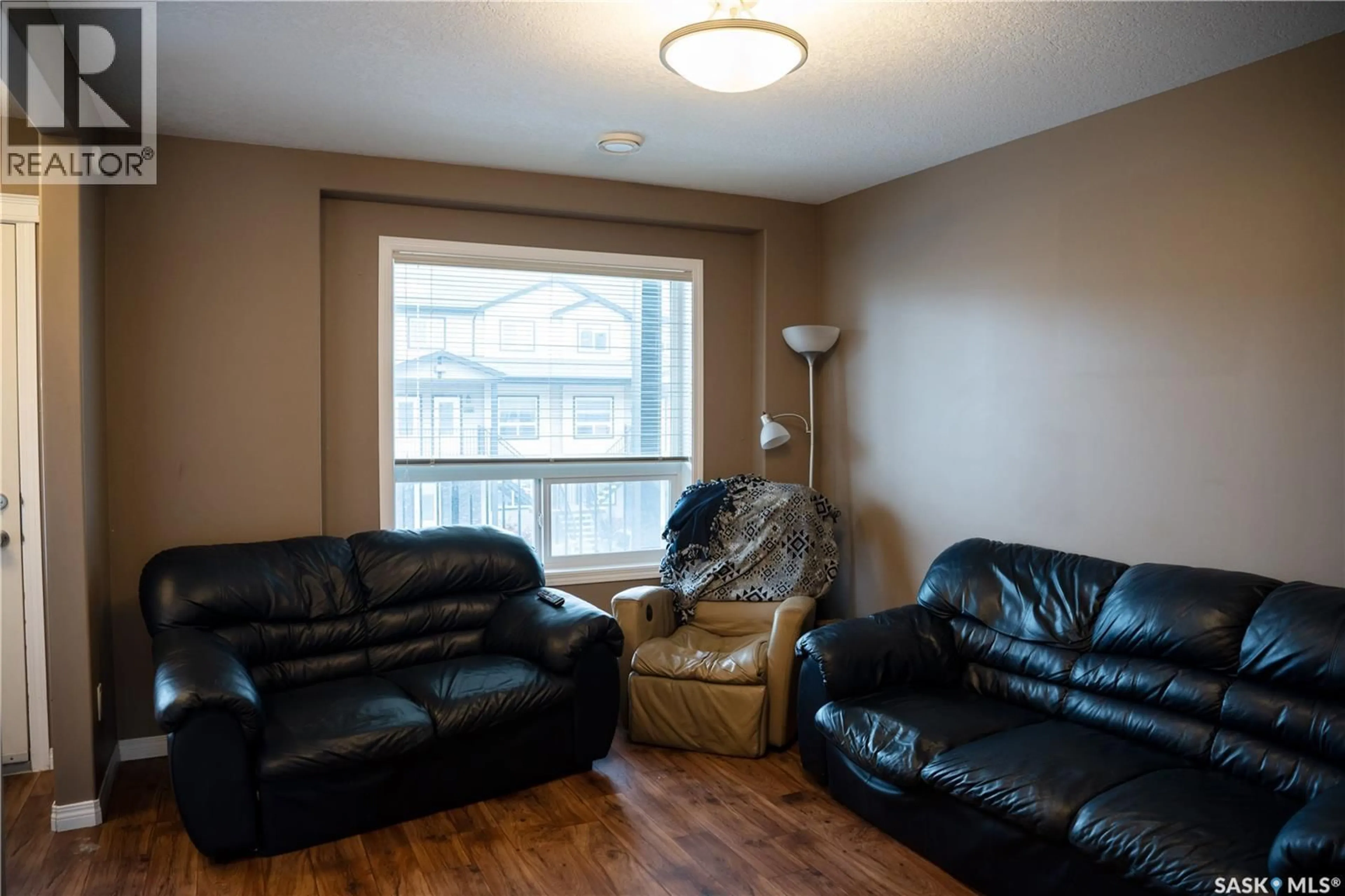 Living room with furniture, wood/laminate floor for 3806 - 714 DEWDNEY AVENUE, Regina Saskatchewan S4Z0A6