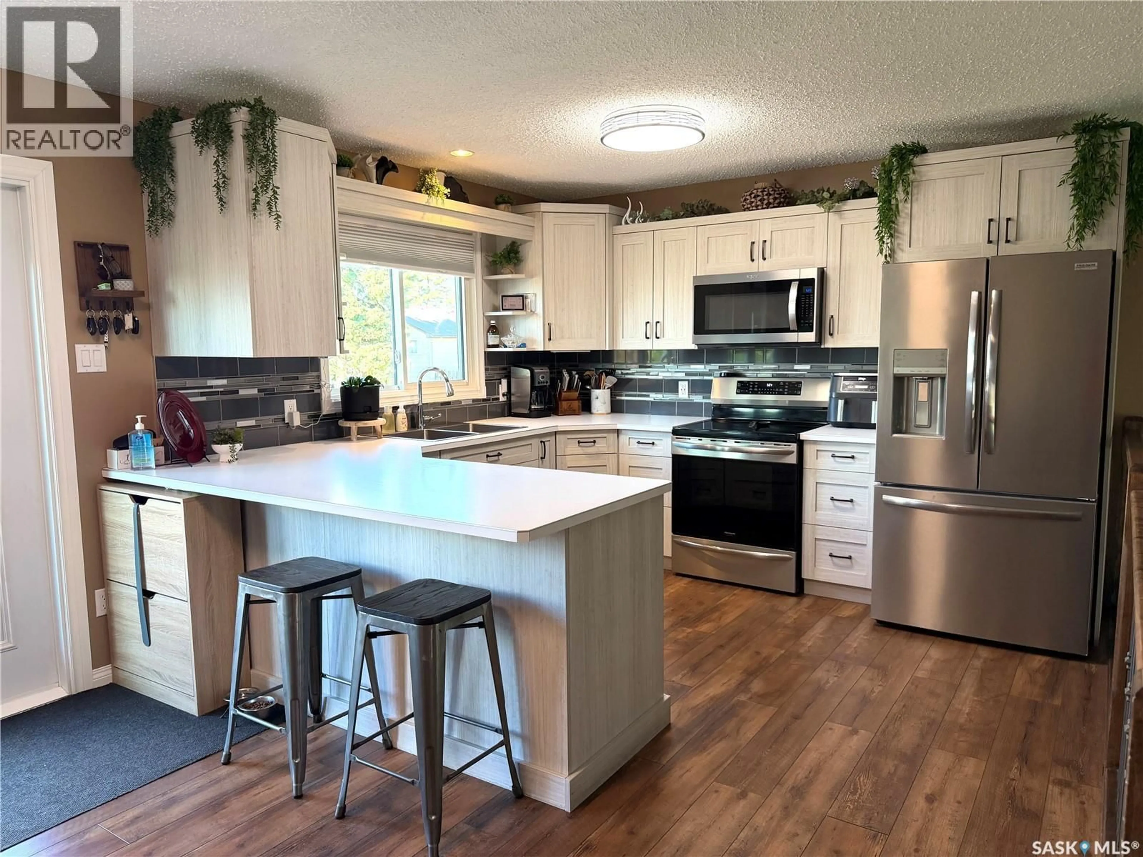 Open concept kitchen, wood/laminate floor for 219 4TH AVENUE, Spiritwood Saskatchewan S0J2M0
