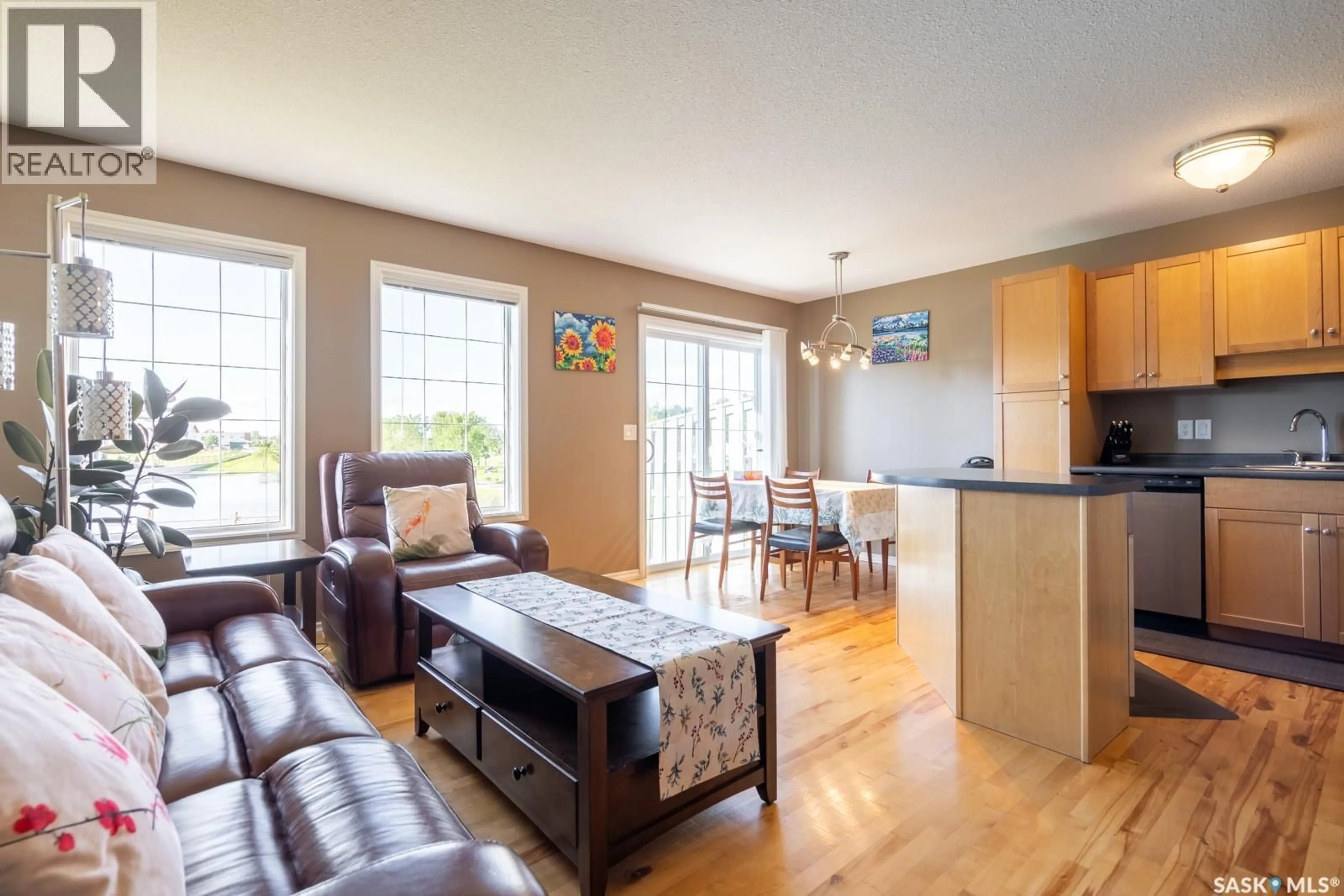 Living room with furniture, wood/laminate floor for 30 2400 TELL PLACE, Regina Saskatchewan S4V3E3