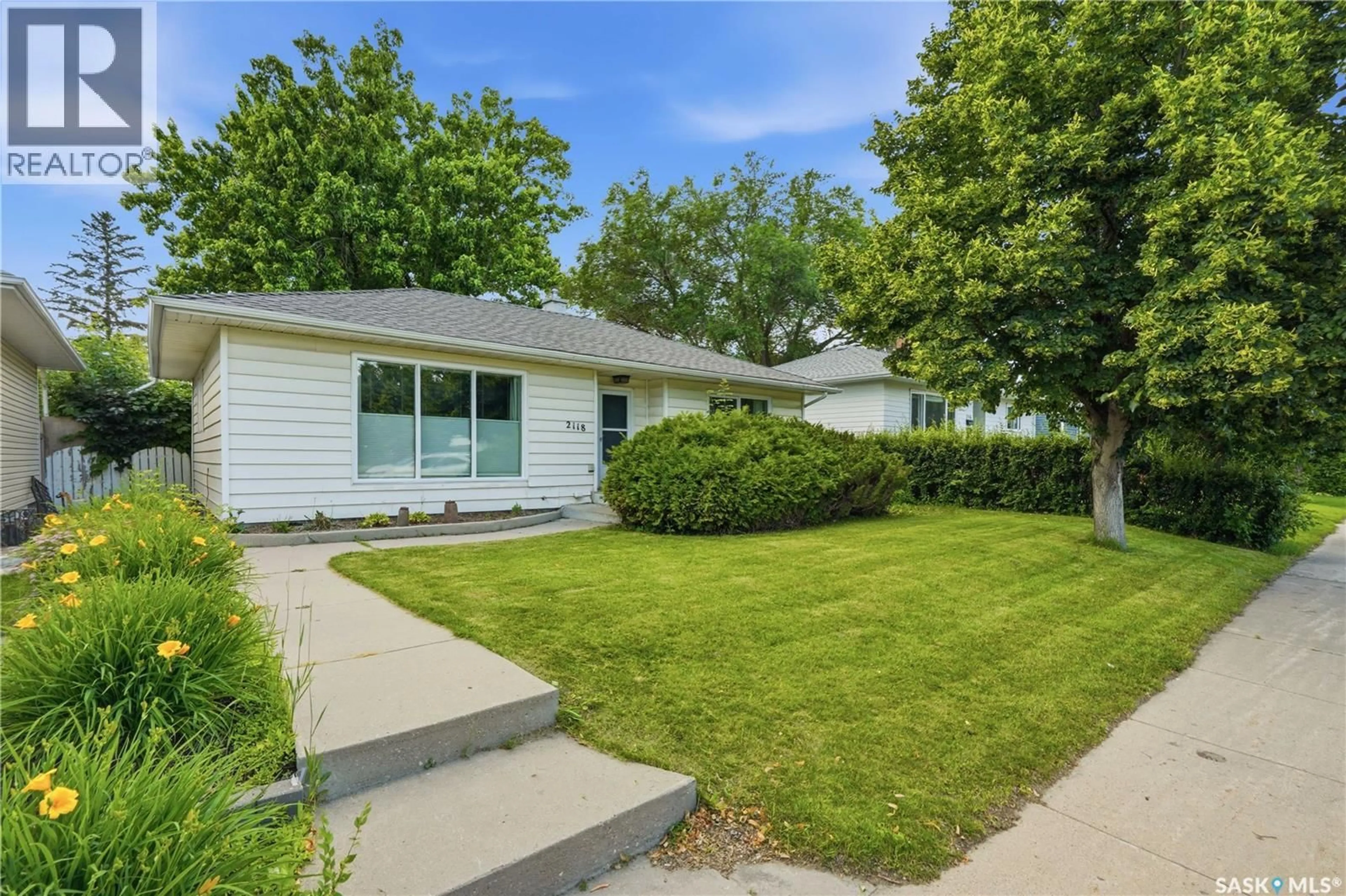 Home with vinyl exterior material, street for 2118 CLARENCE AVENUE, Saskatoon Saskatchewan S7J1L5