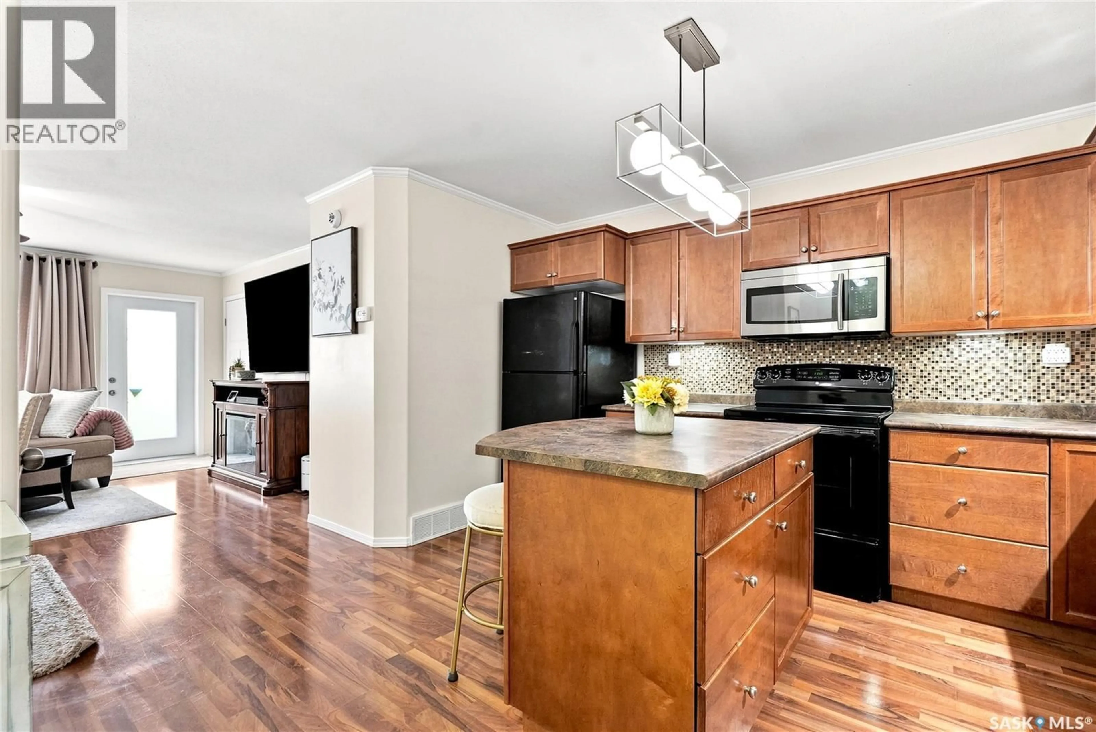 Open concept kitchen, wood/laminate floor for 1101 715 HART ROAD, Saskatoon Saskatchewan S7M3Y9