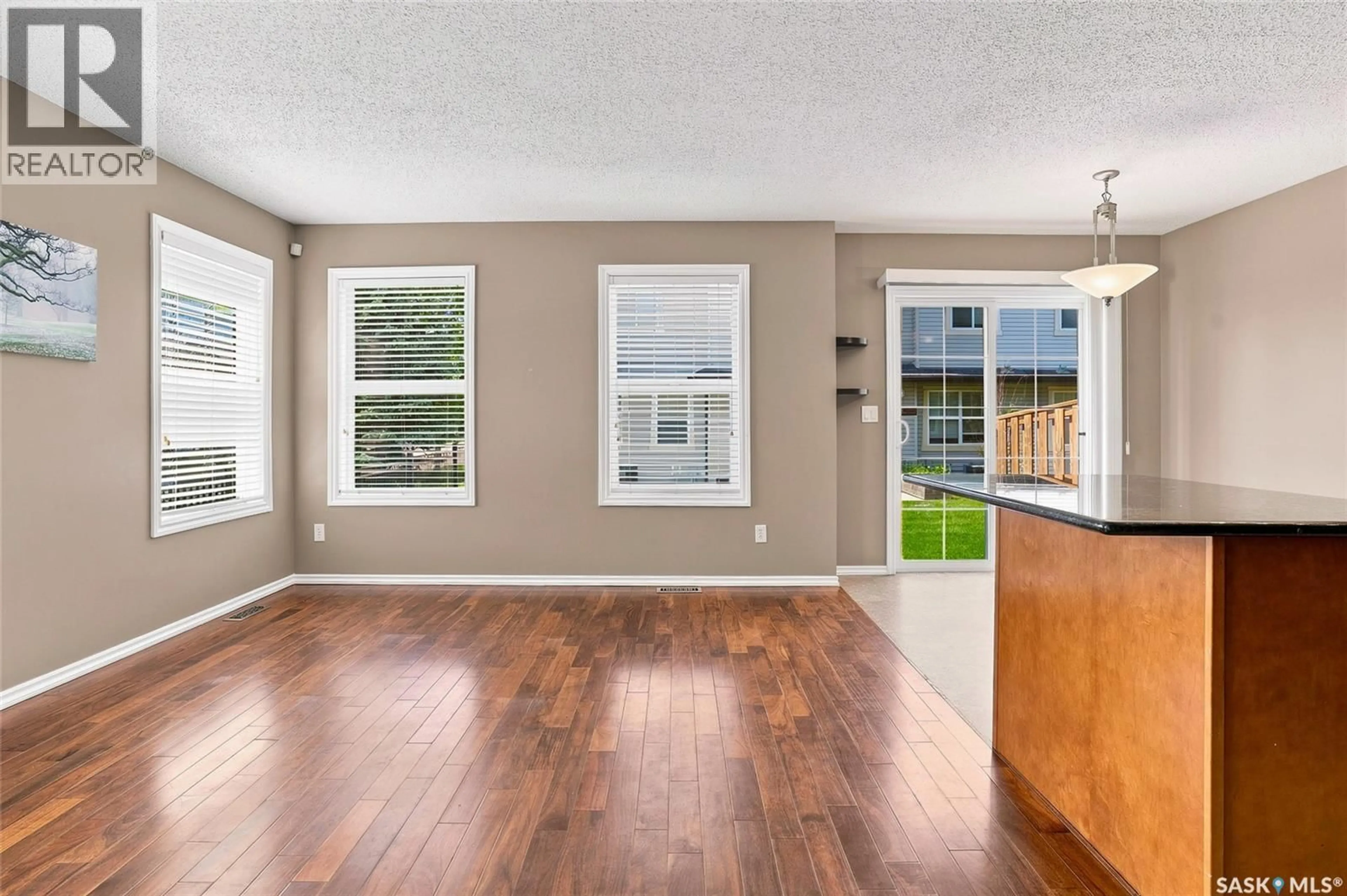 Open concept kitchen, wood/laminate floor for 105 - 201 LYND CRESCENT, Saskatoon Saskatchewan S7T0C3