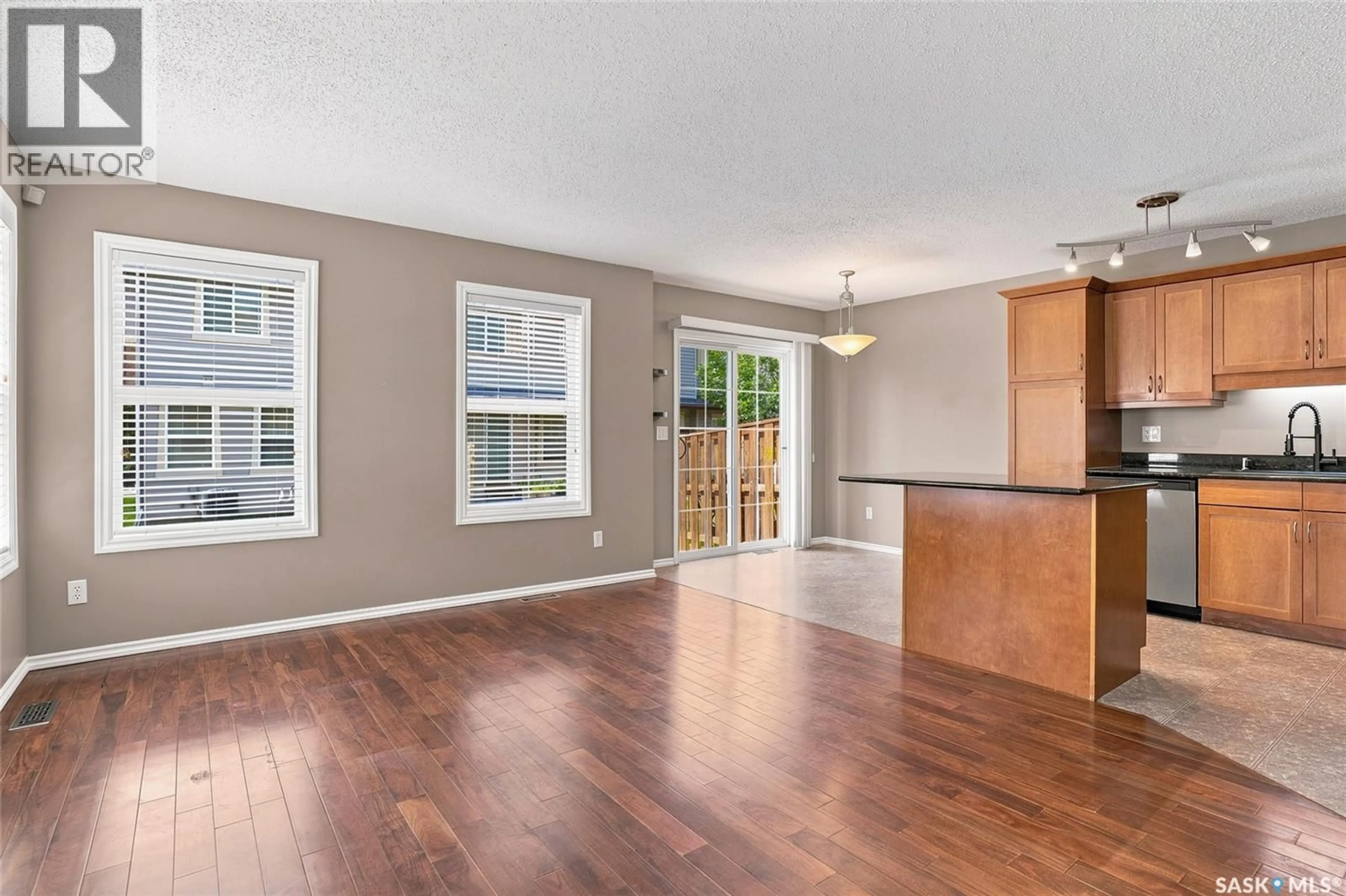 Open concept kitchen, wood/laminate floor for 105 - 201 LYND CRESCENT, Saskatoon Saskatchewan S7T0C3